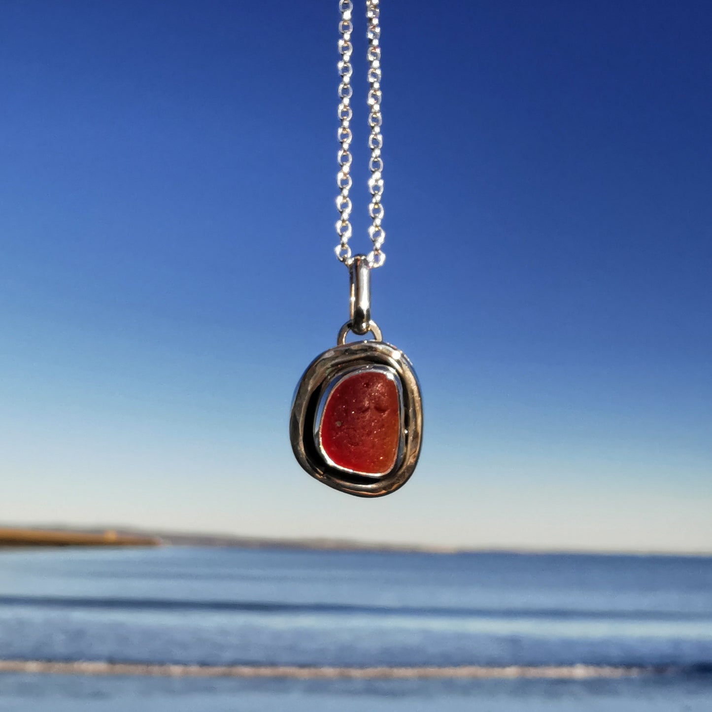 Red amberina sea glass & sterling silver pendant.