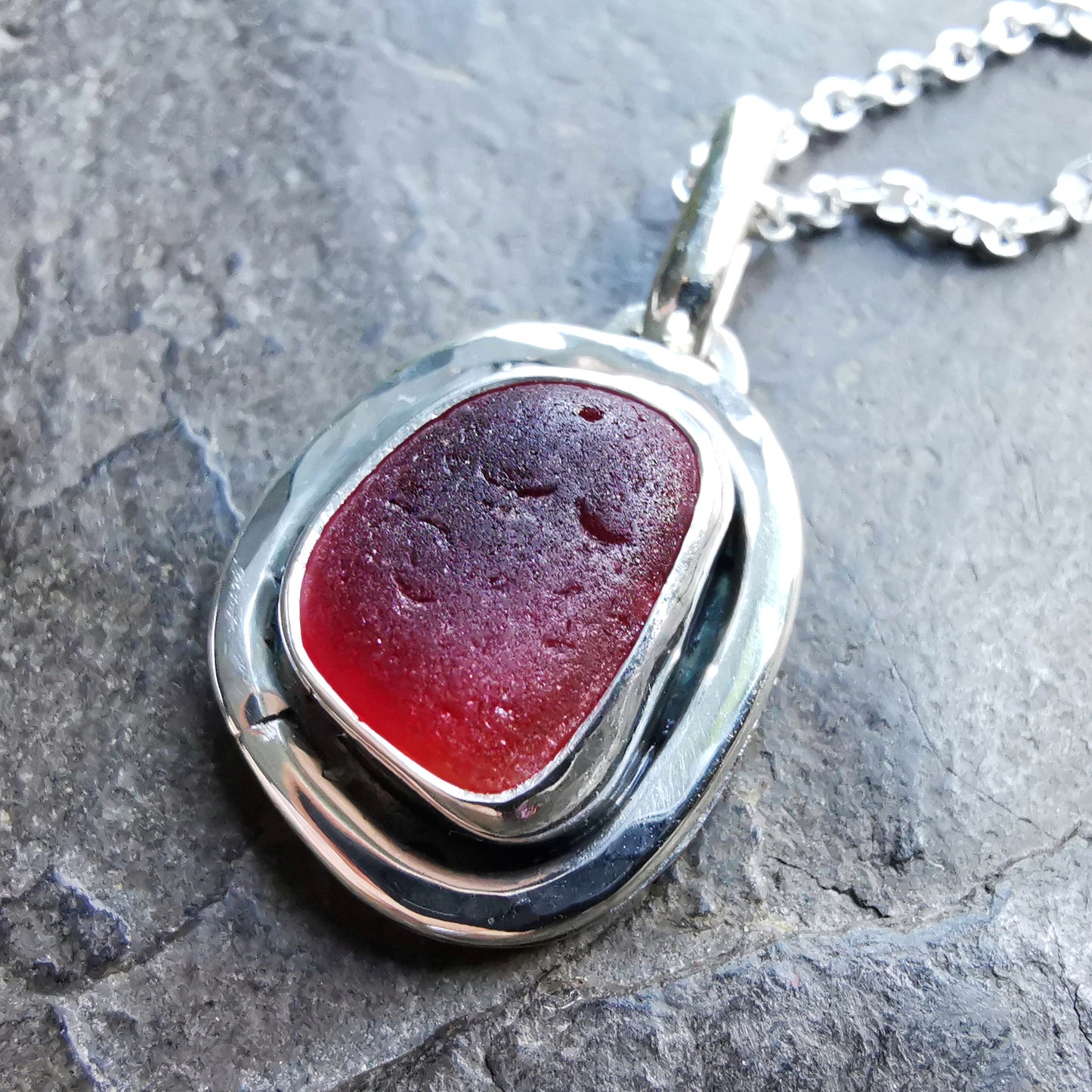 Red amberina sea glass & sterling silver pendant.