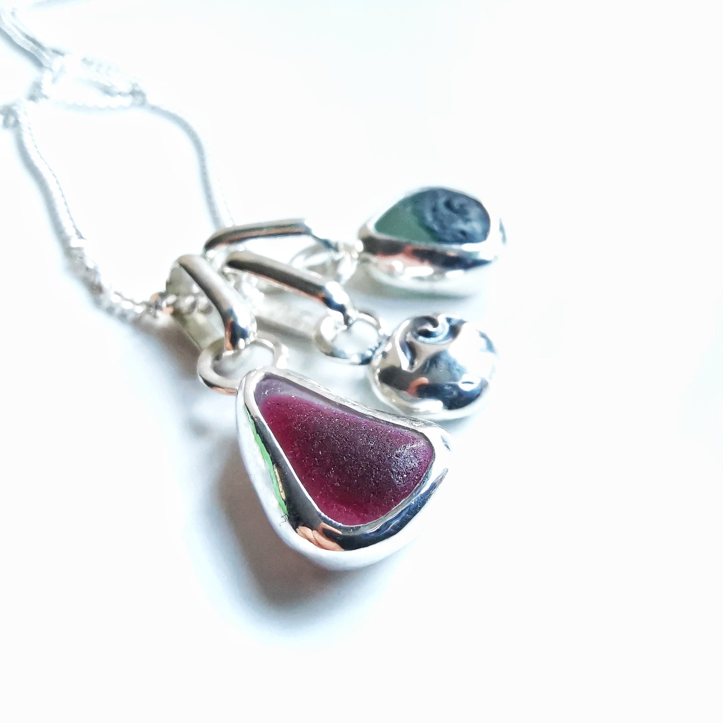 Tiny Seaham pink and green sea glass charms & sterling silver wave pebble trio.