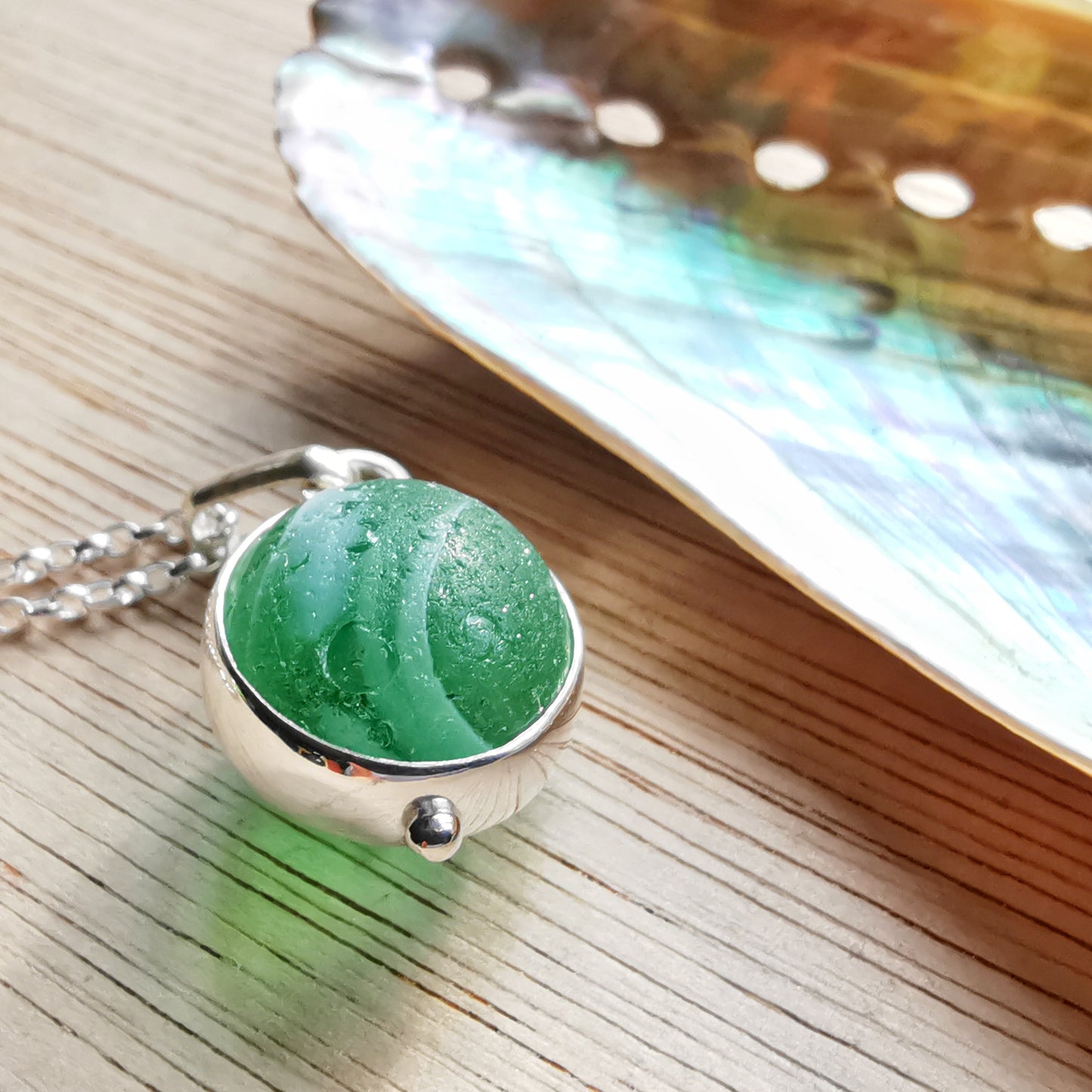 Genuine green sea glass marble & sterling silver pendant.