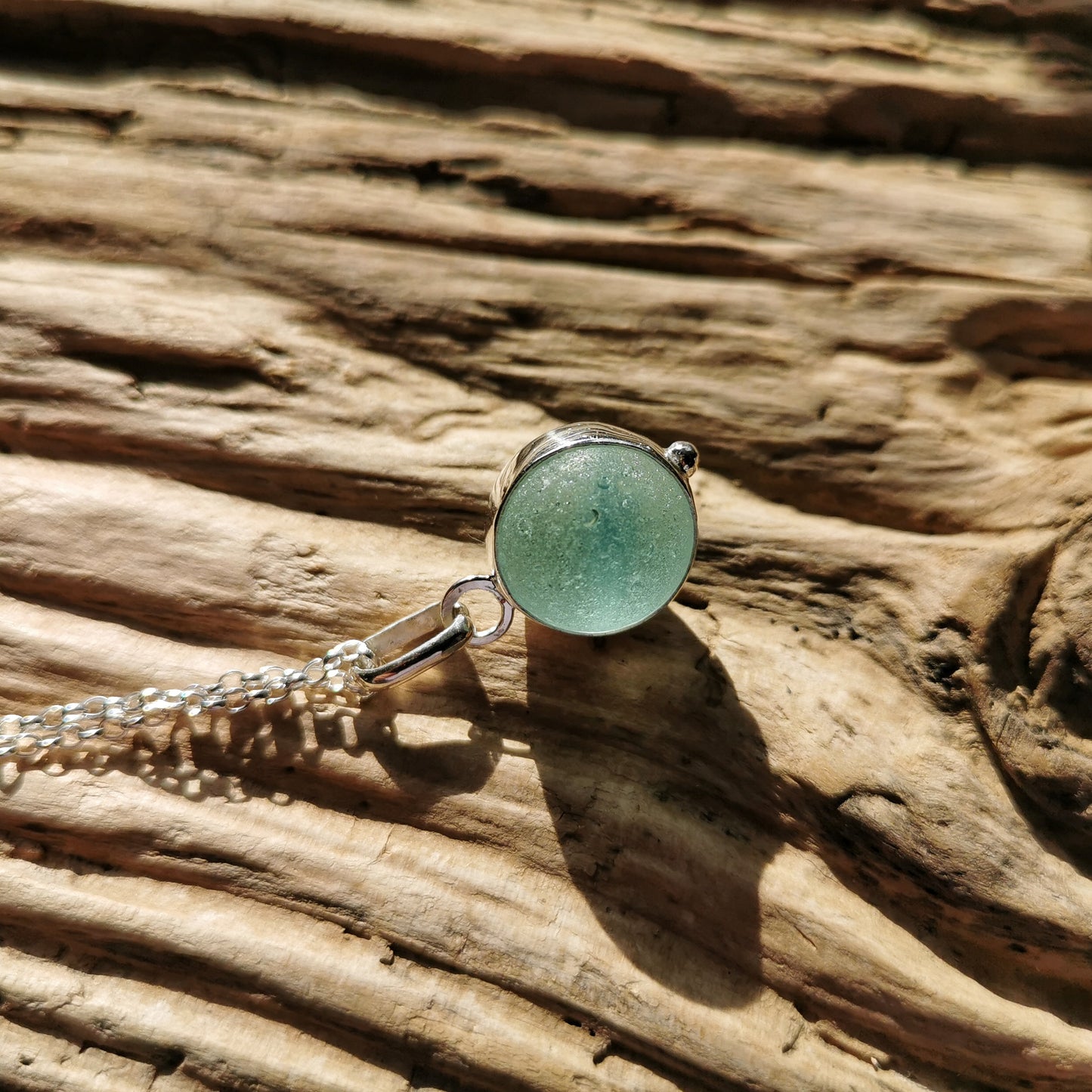 Light blue sea glass marble & sterling silver pendant.