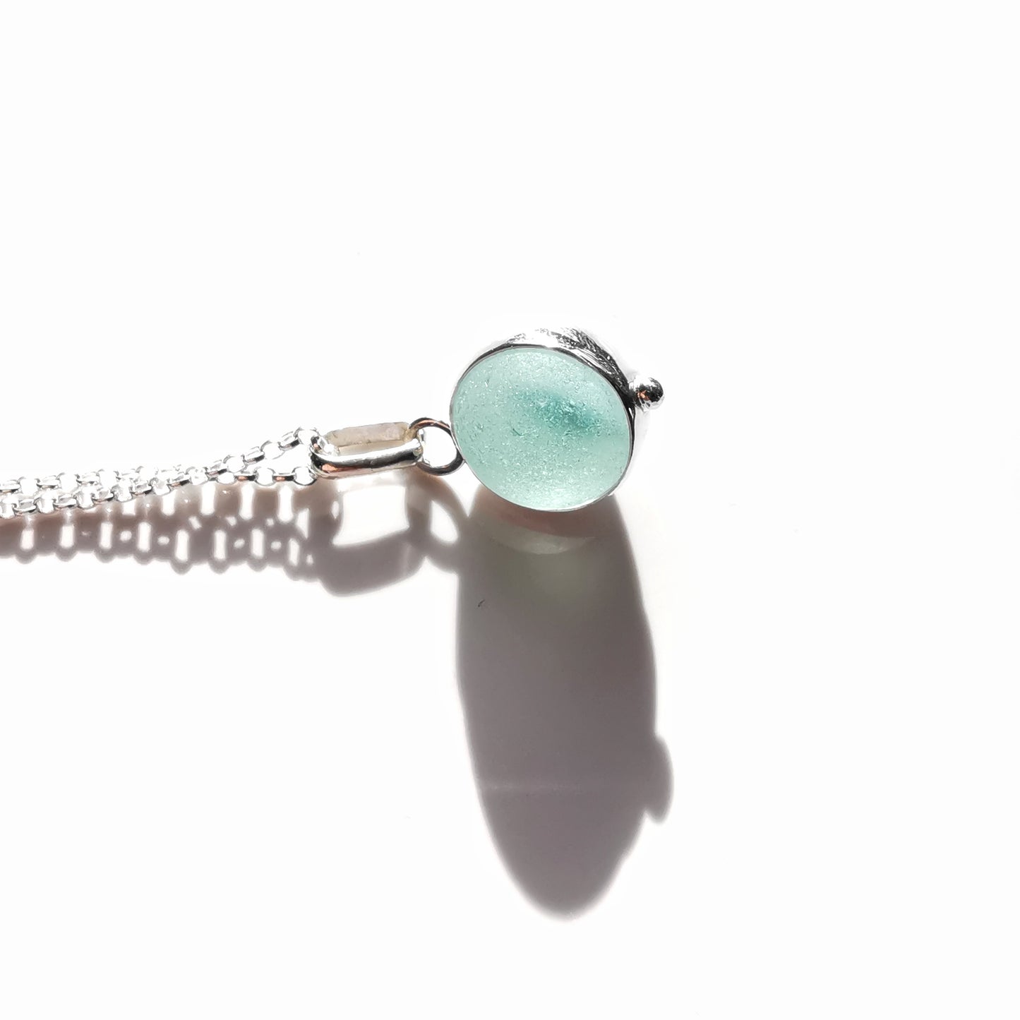 Light blue sea glass marble & sterling silver pendant.