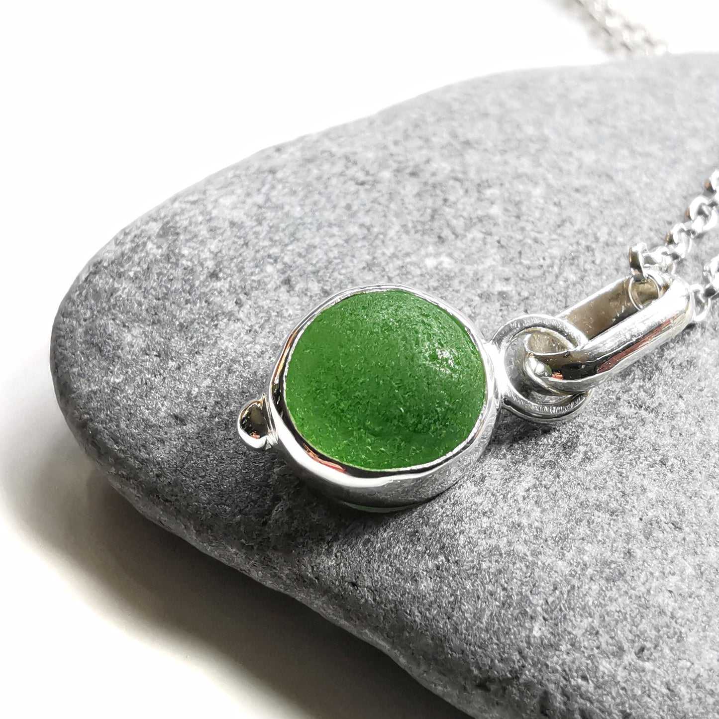 Tiny Scottish green sea glass marble & sterling silver pendant.