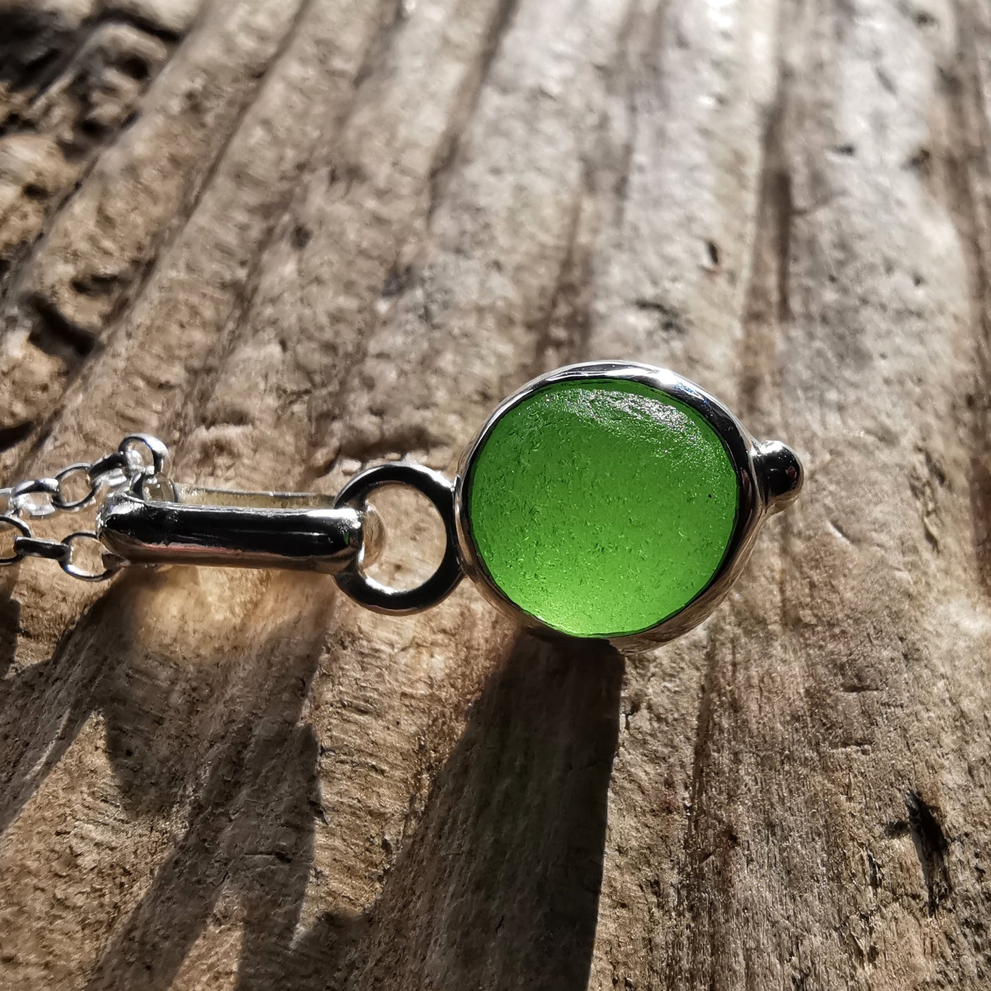 Tiny Scottish green sea glass marble & sterling silver pendant.