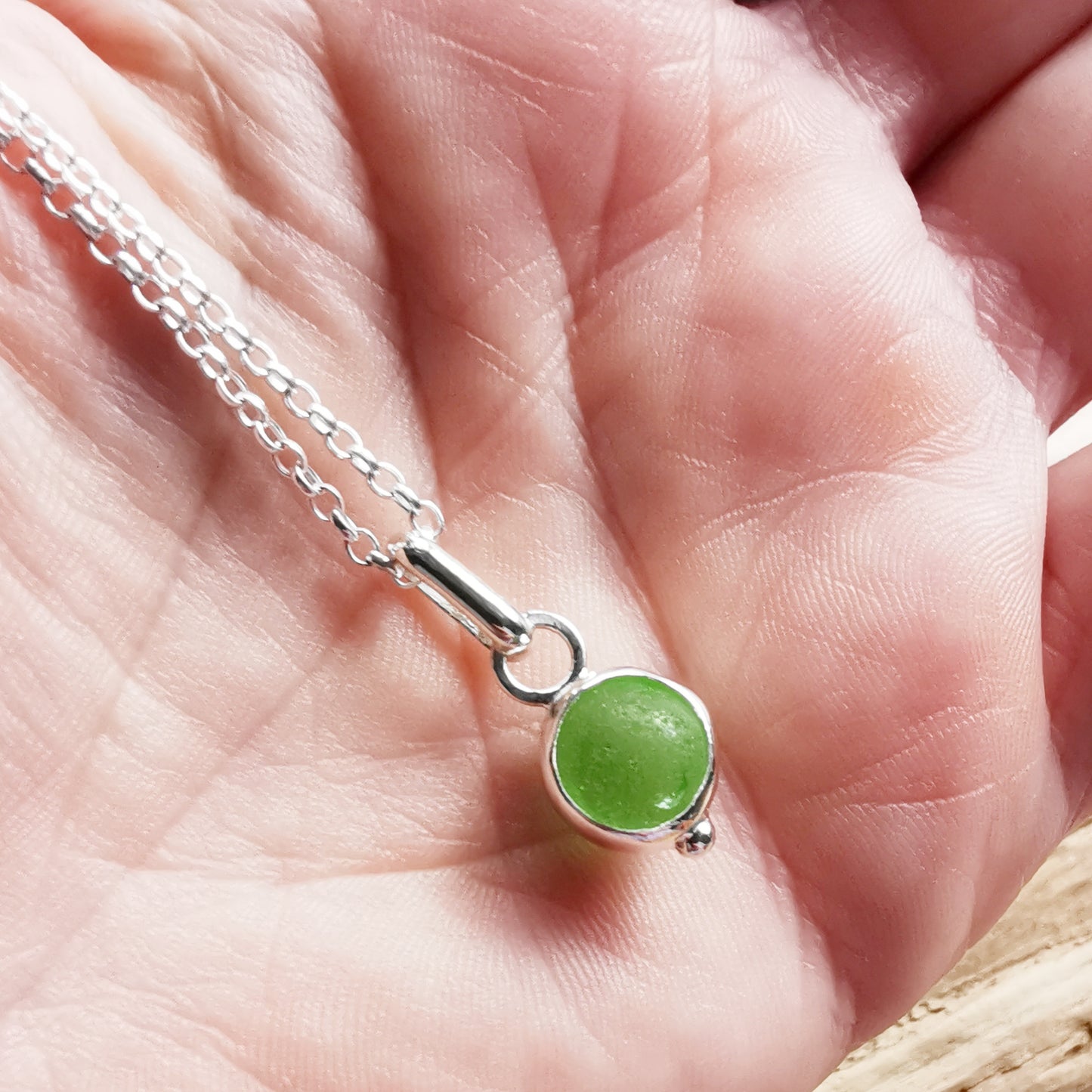 Tiny Scottish green sea glass marble & sterling silver pendant.