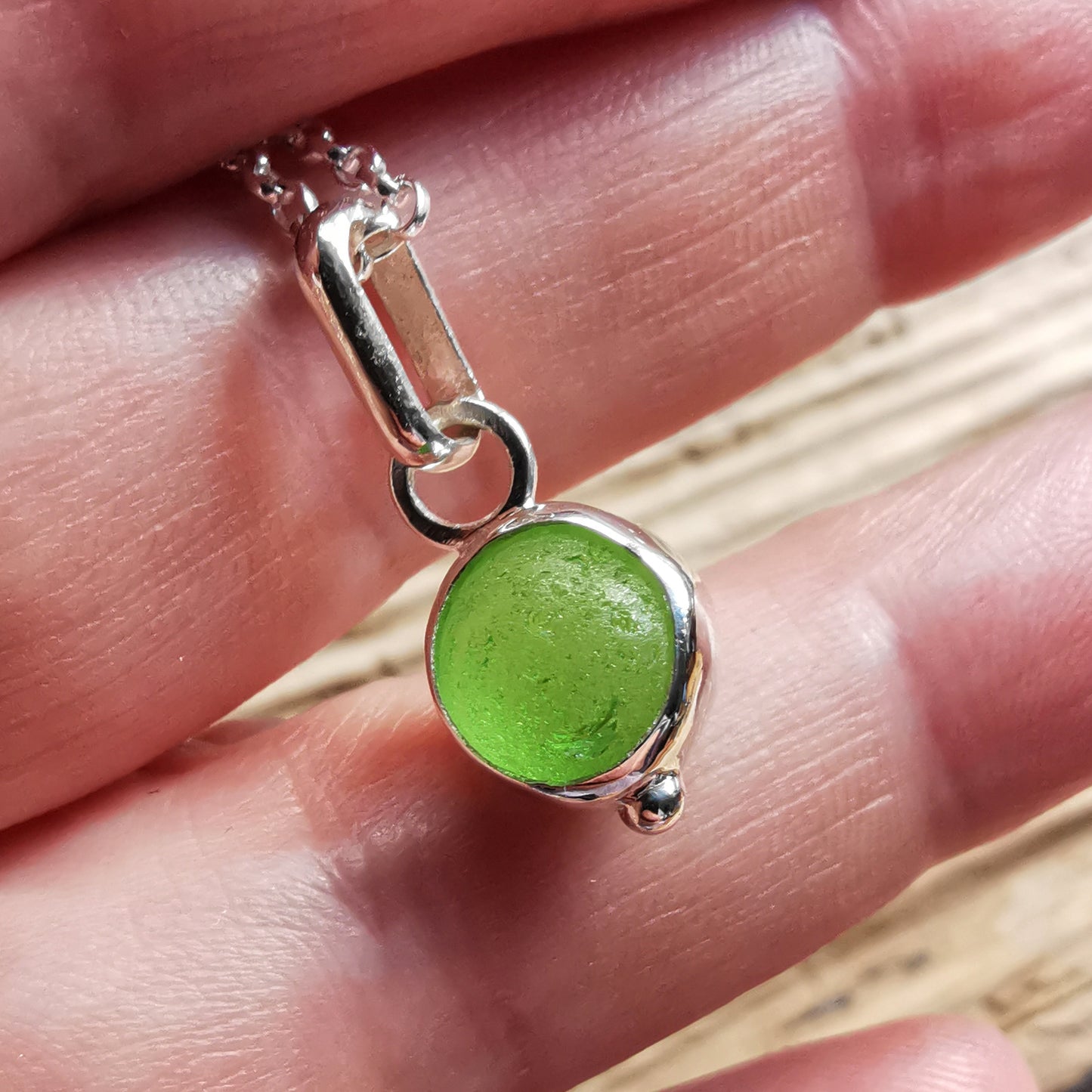 Tiny Scottish green sea glass marble & sterling silver pendant.