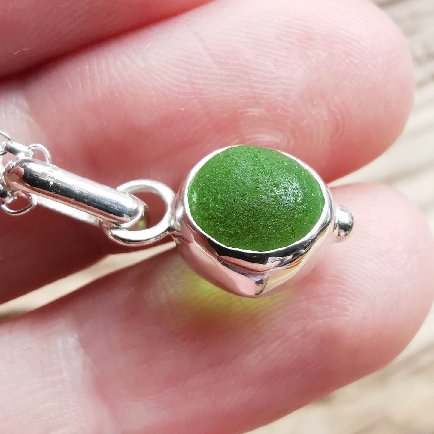 Tiny Scottish green sea glass marble & sterling silver pendant.