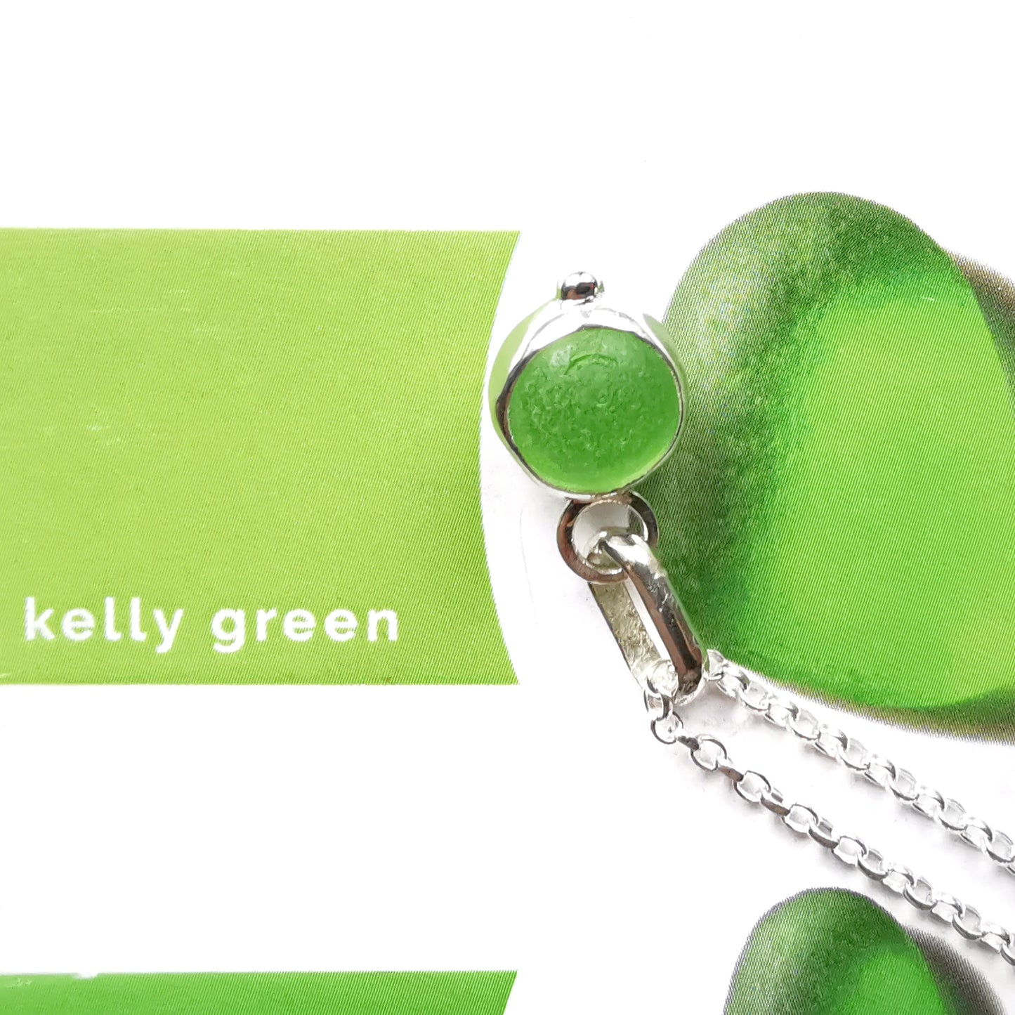 Tiny Scottish green sea glass marble & sterling silver pendant.