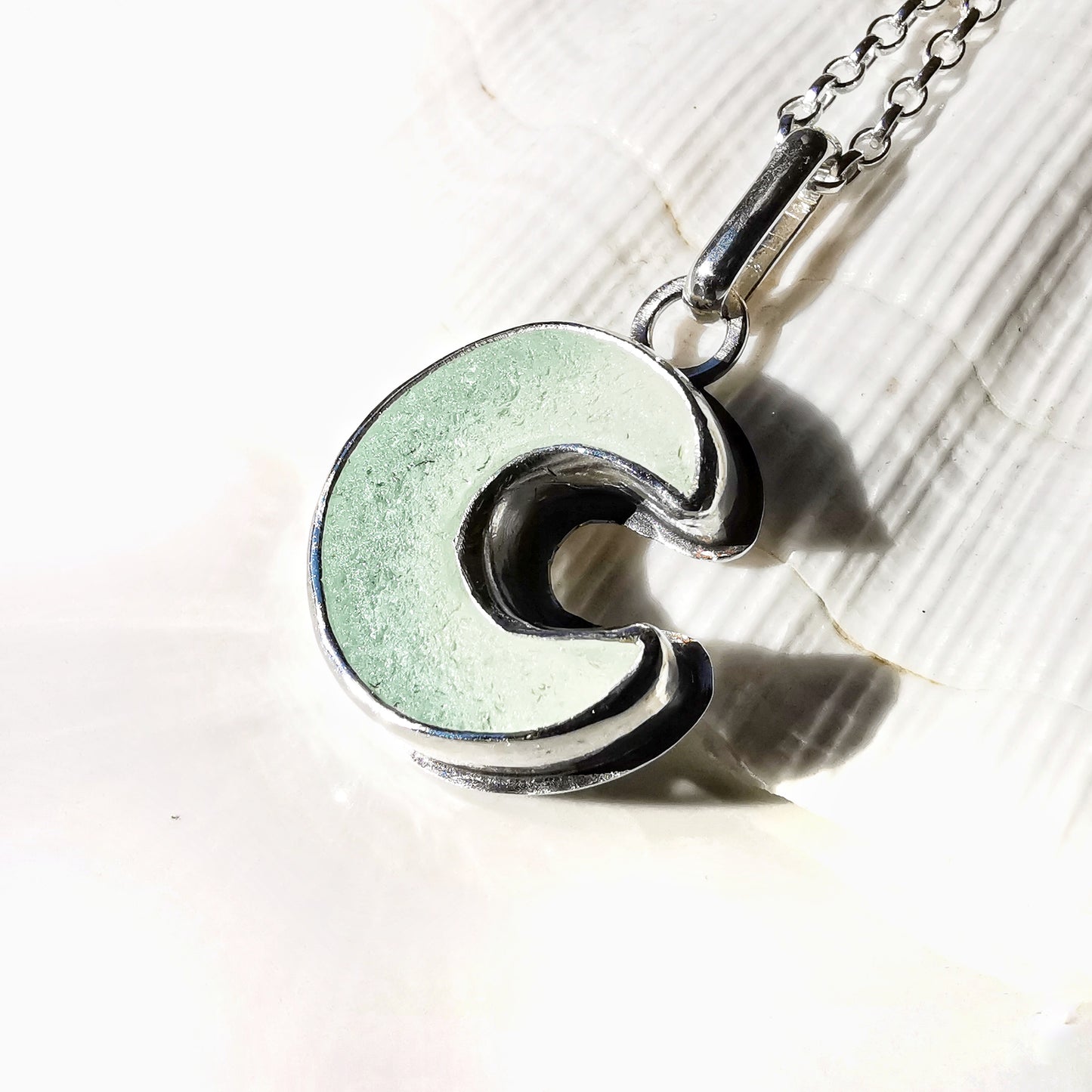 Opalescent crescent moon sea glass & sterling silver pendant.