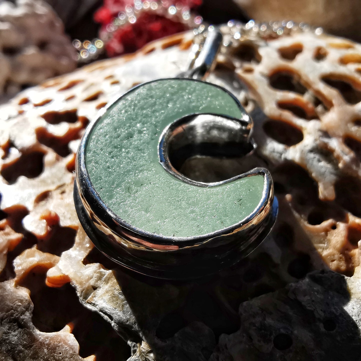 Opalescent crescent moon sea glass & sterling silver pendant.