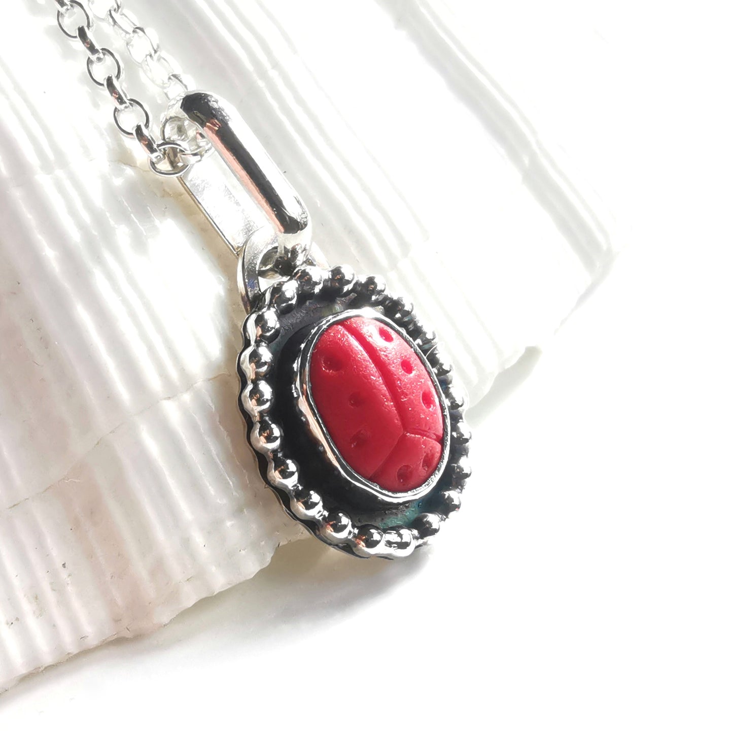 Tiny red sea glass ladybird & sterling silver pendant.