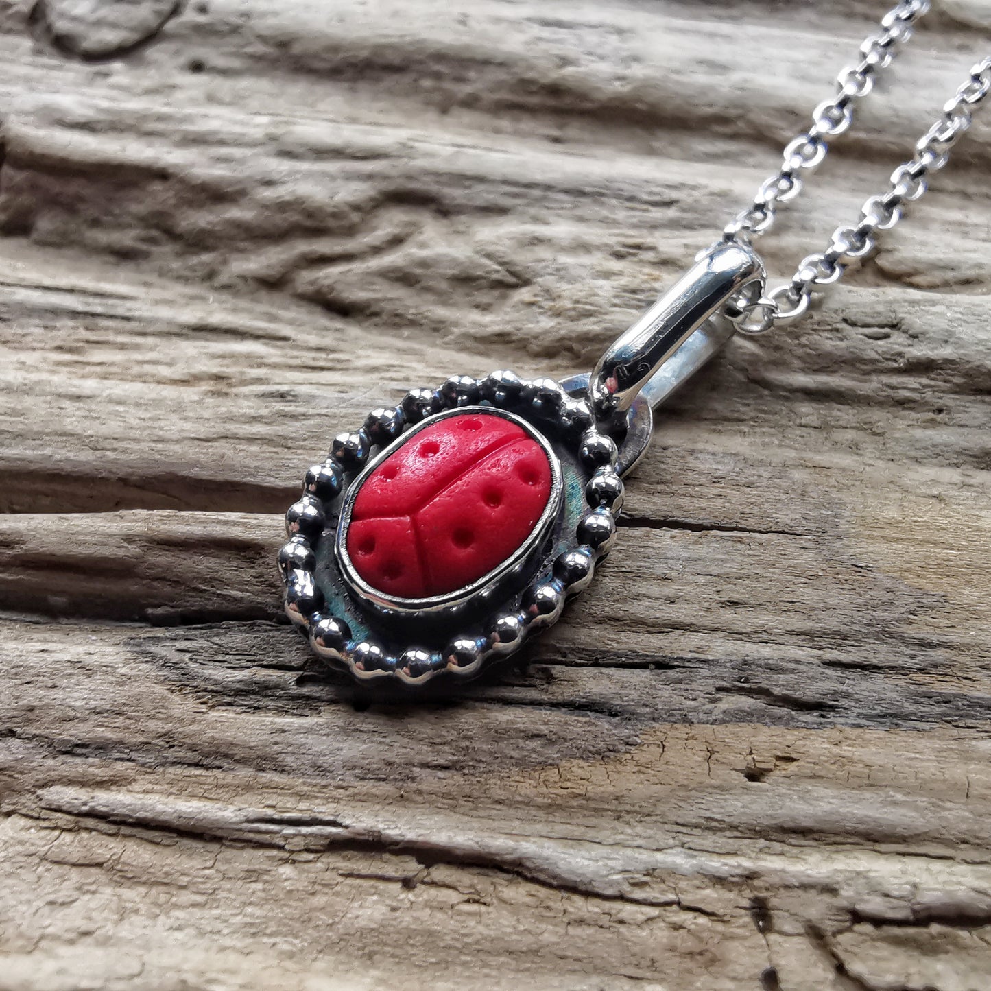 Tiny red sea glass ladybird & sterling silver pendant.