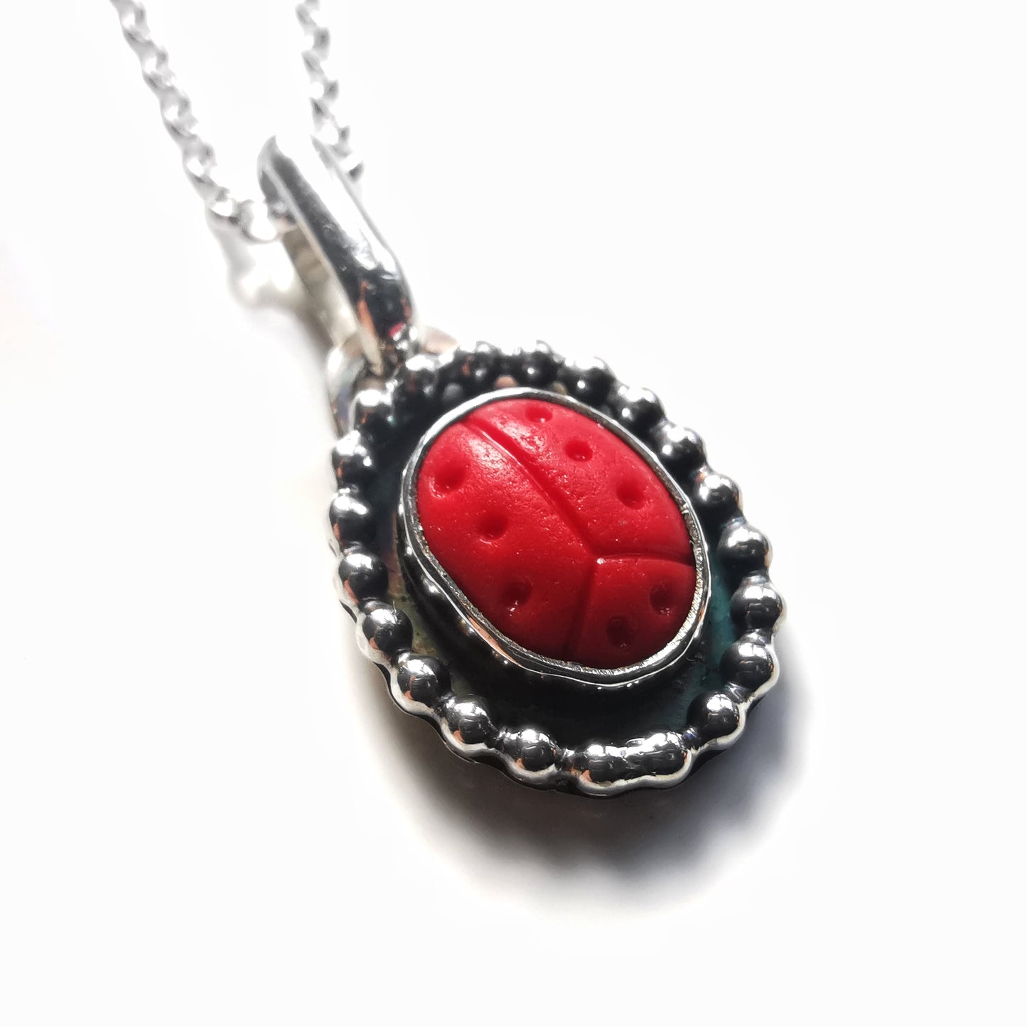 Tiny red sea glass ladybird & sterling silver pendant.