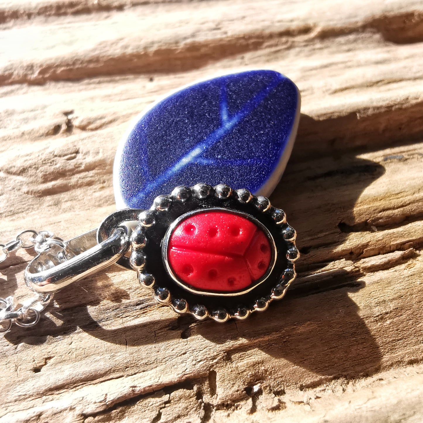 Tiny red sea glass ladybird & sterling silver pendant.