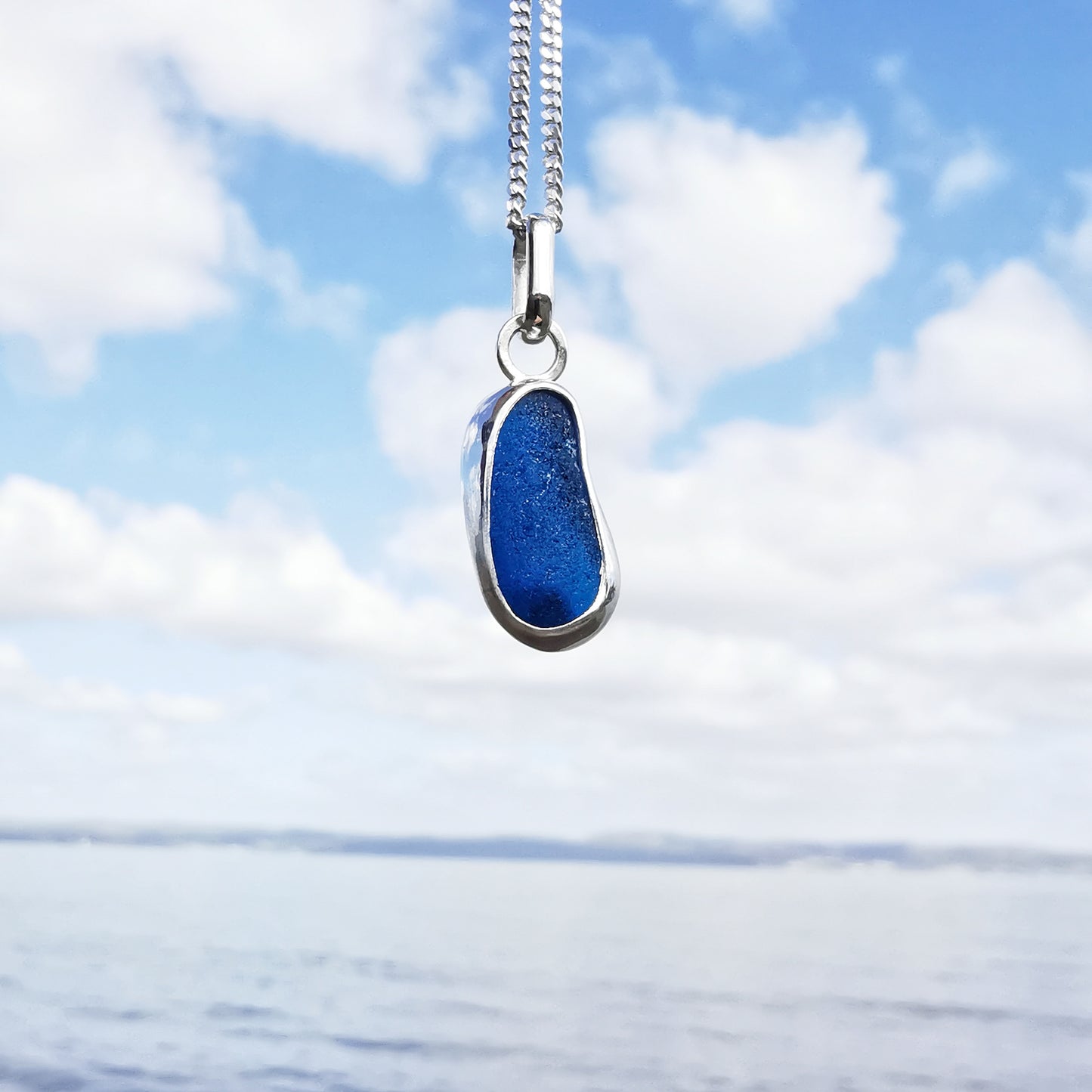 Teal blue 'jelly bean' sea glass & sterling silver pendant.