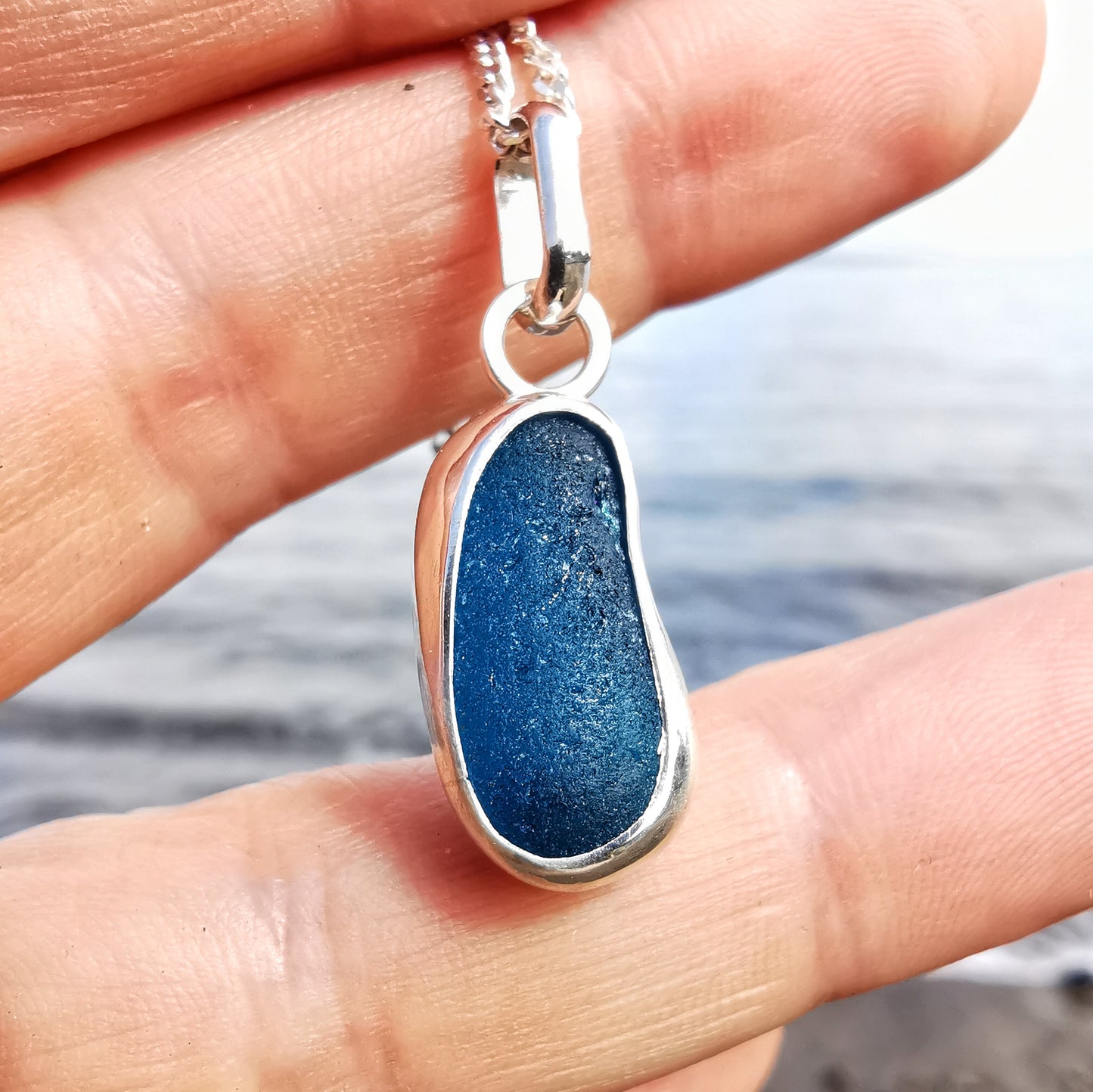 Teal blue 'jelly bean' sea glass & sterling silver pendant.