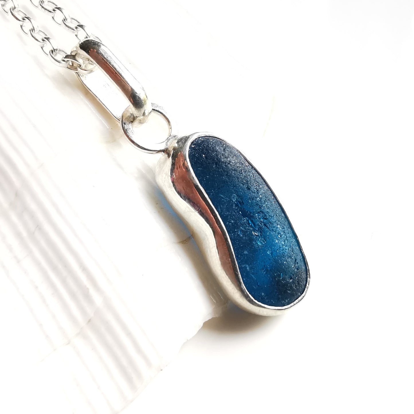 Teal blue 'jelly bean' sea glass & sterling silver pendant.