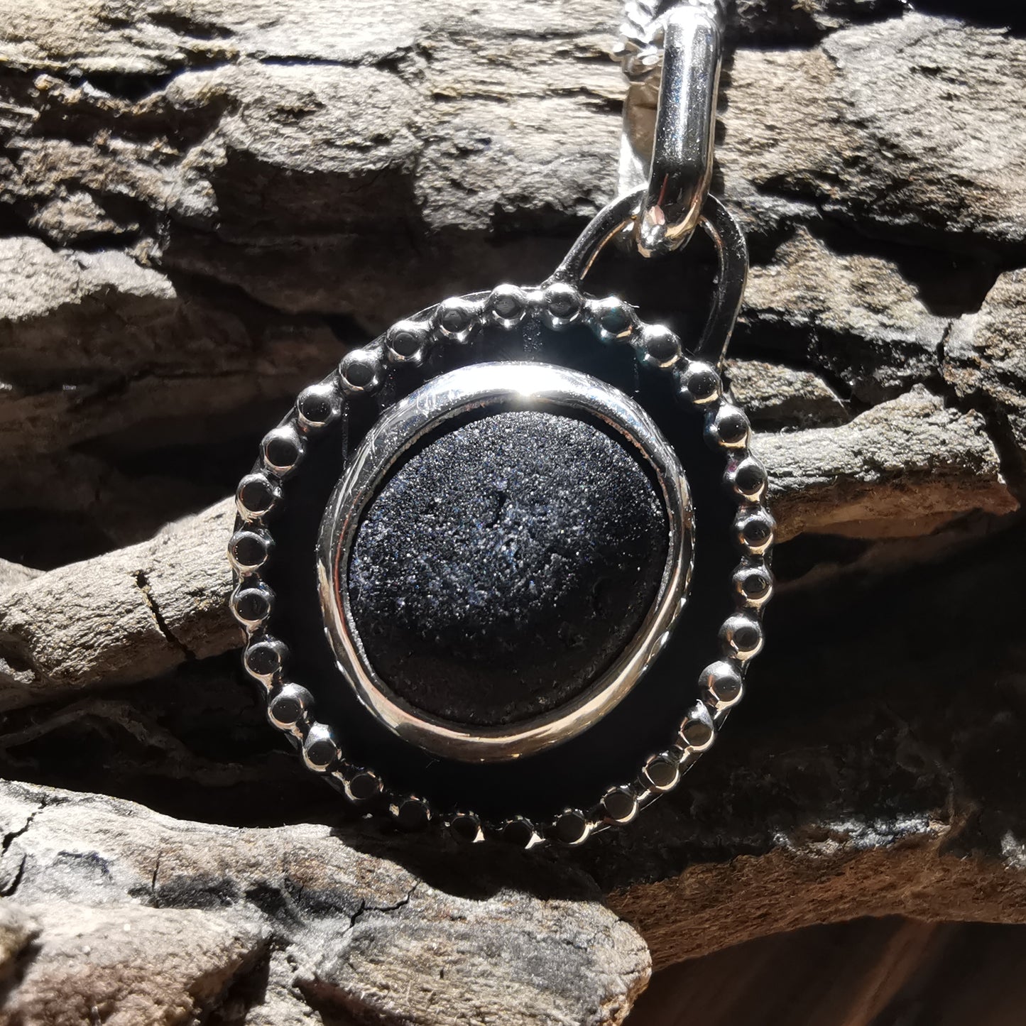 Seaham black sea glass with hidden colour & sterling silver pendant.