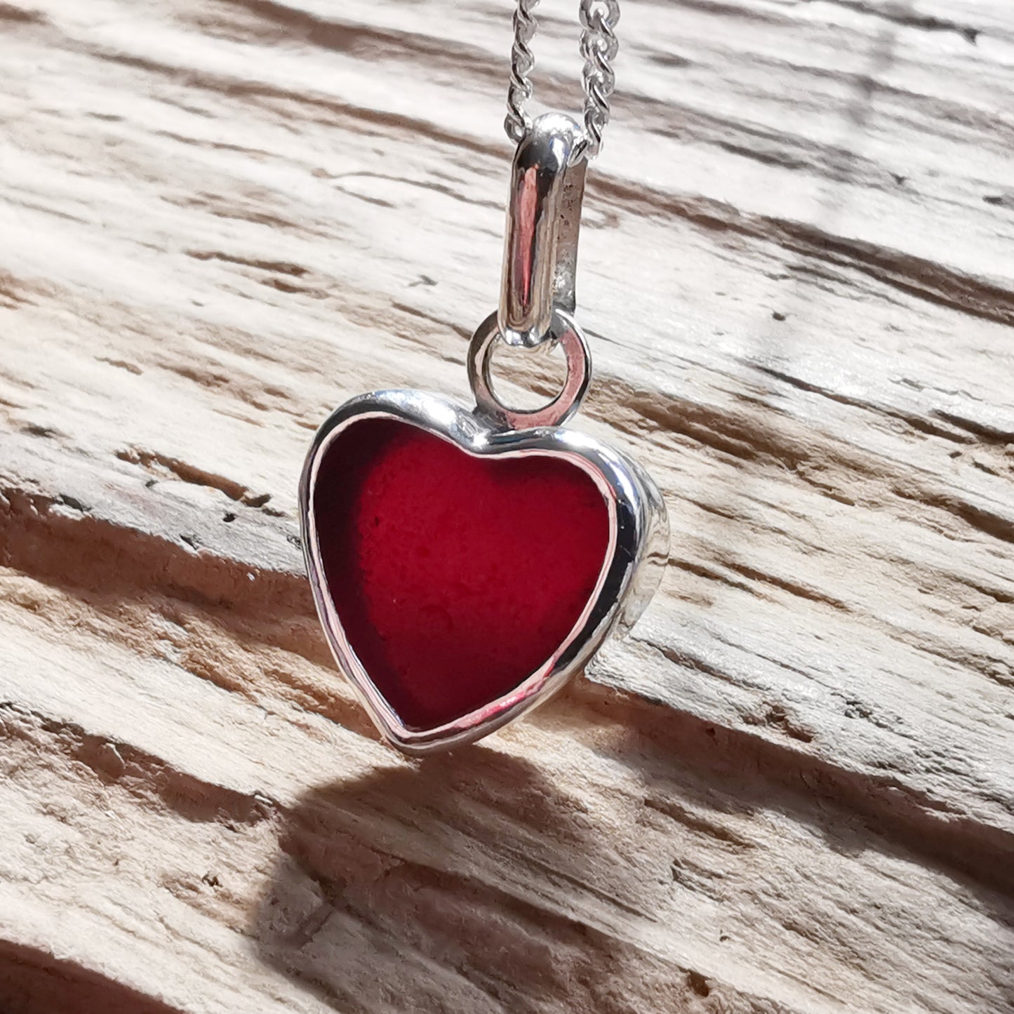 Burgundy red sea glass heart & sterling silver pendant.