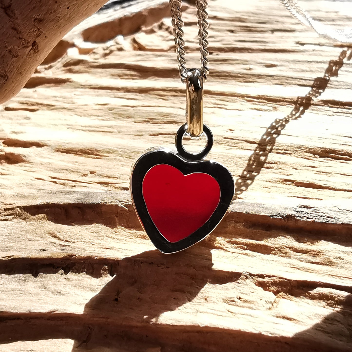 Burgundy red sea glass heart & sterling silver pendant.