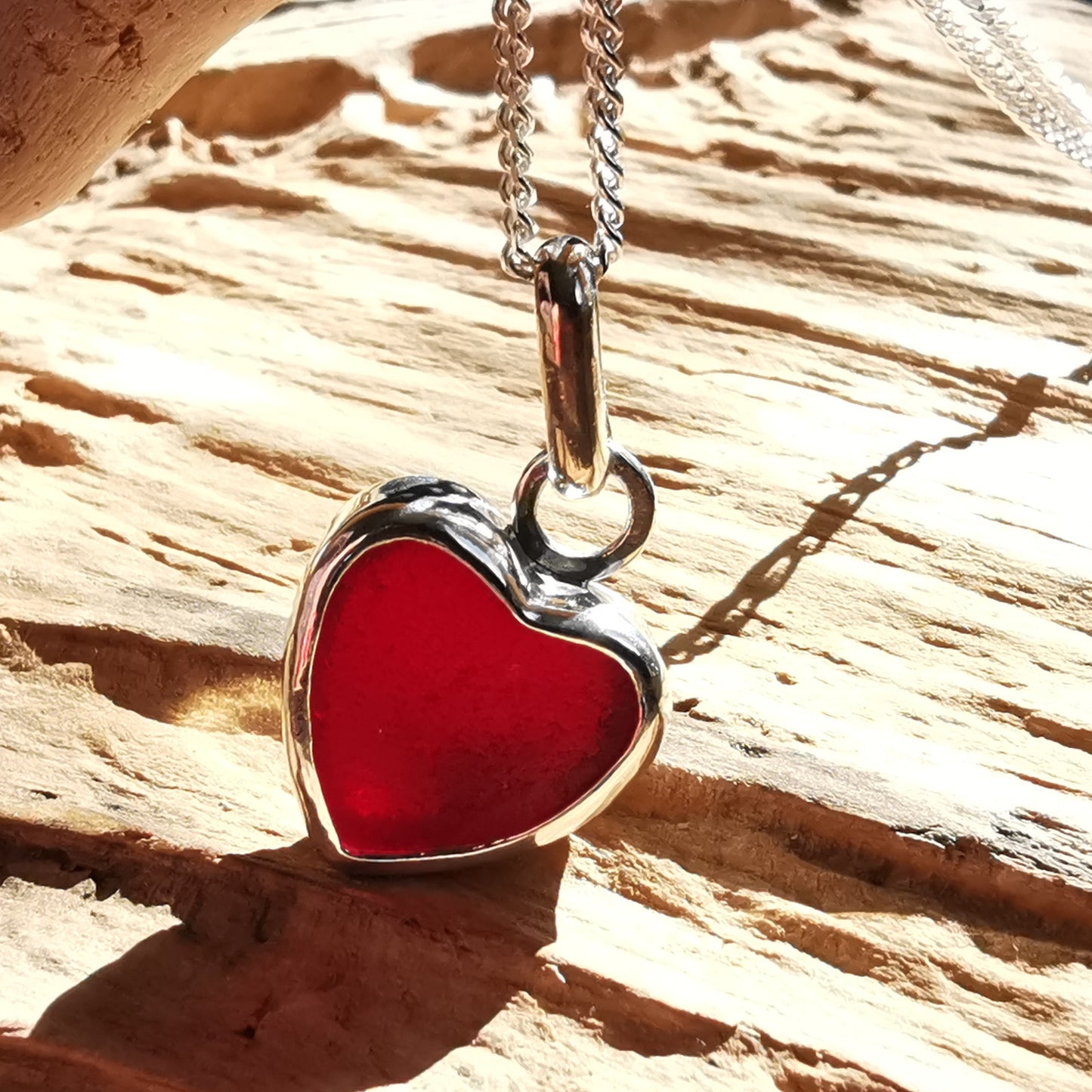 Burgundy red sea glass heart & sterling silver pendant.