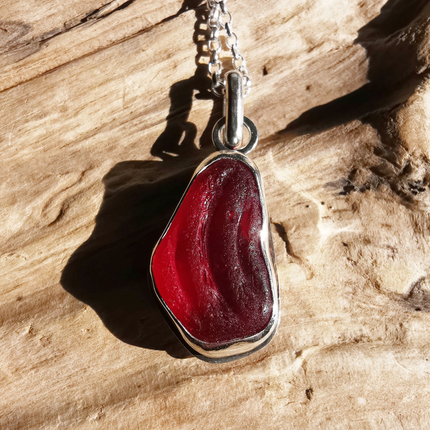 Red UV sea glass & sterling silver pendant.