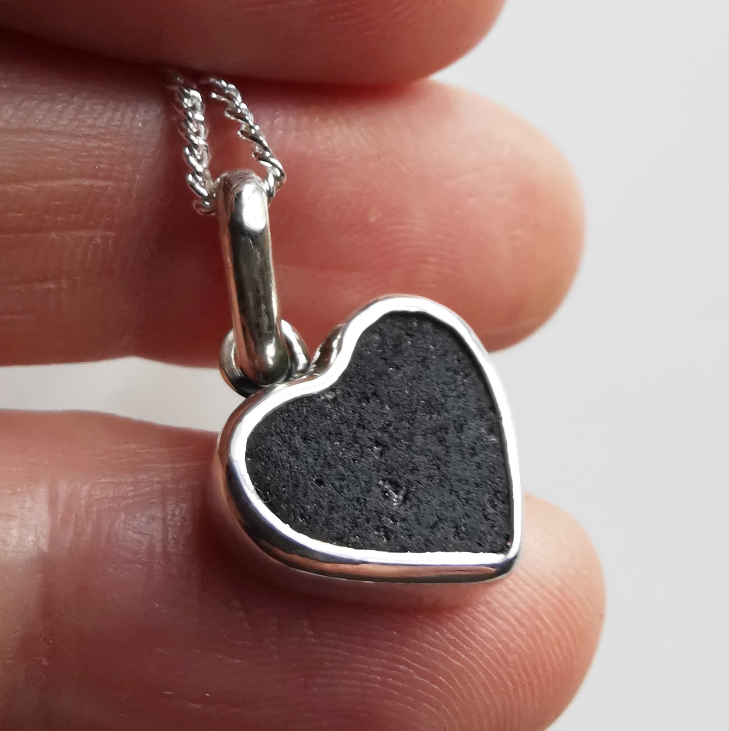 Tiny black Scottish sea glass heart & sterling silver pendant.