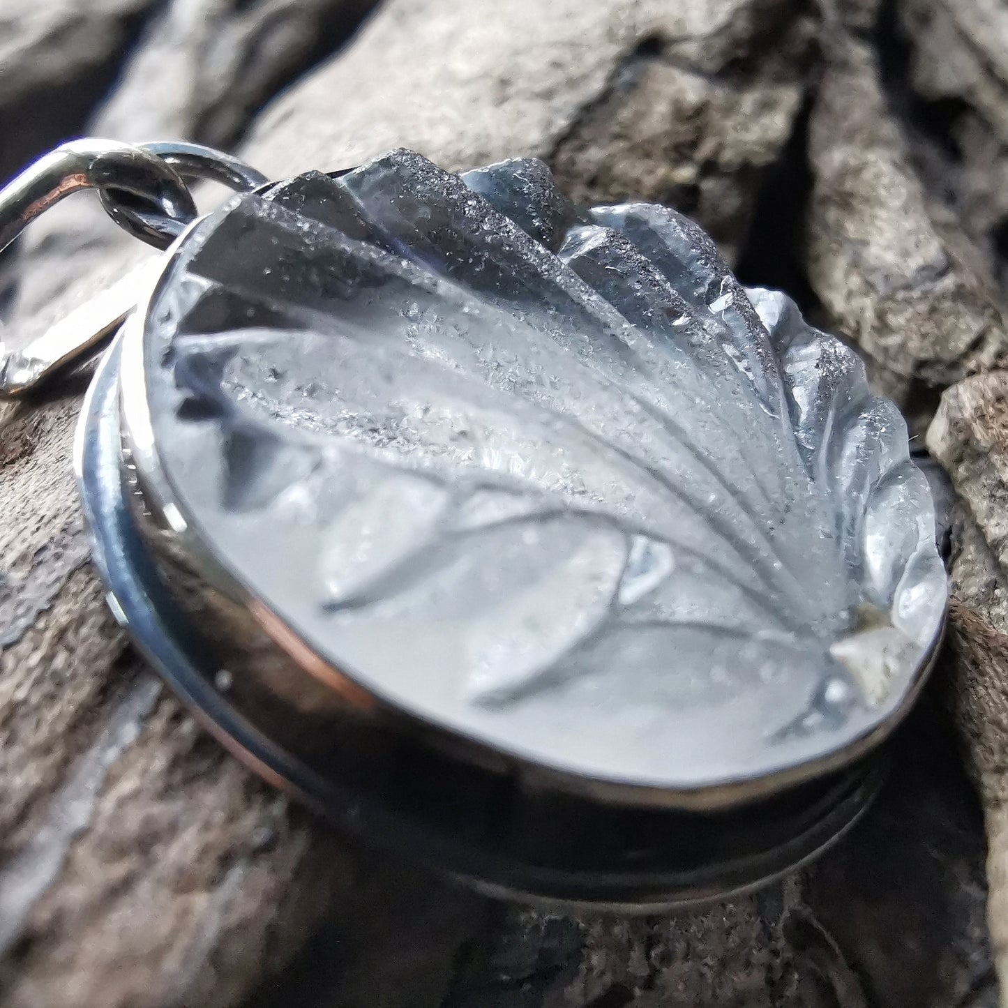 Clear sea glass & sterling silver pendant.