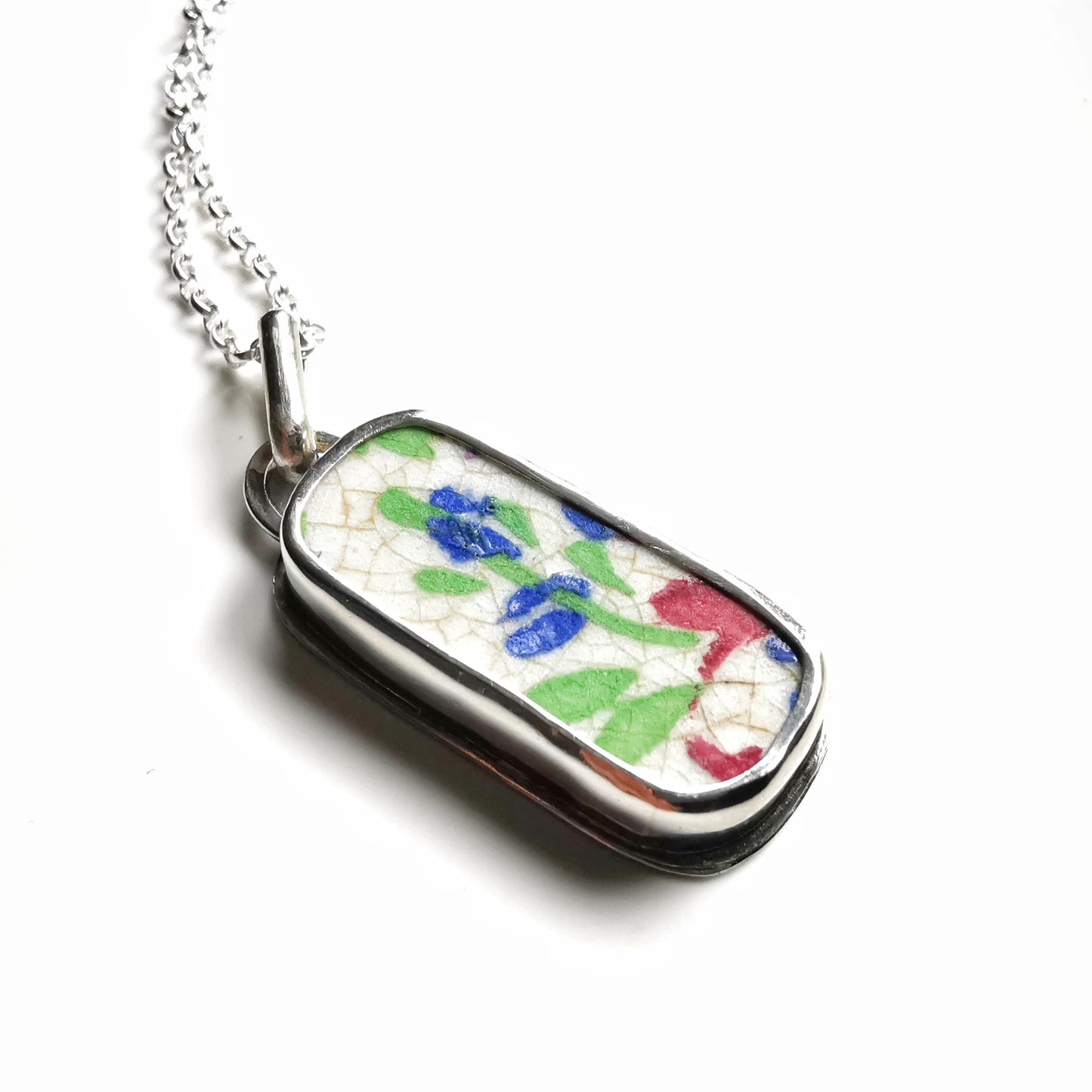 Scottish foliage pattern sea pottery & sterling silver pendant.