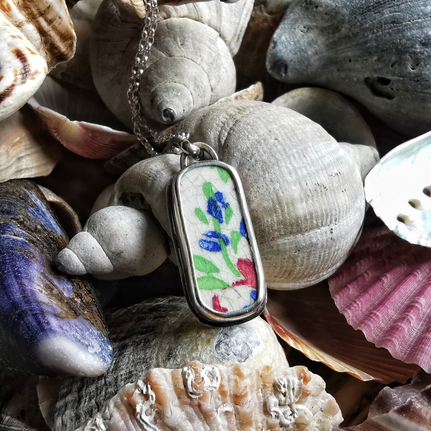 Scottish foliage pattern sea pottery & sterling silver pendant.
