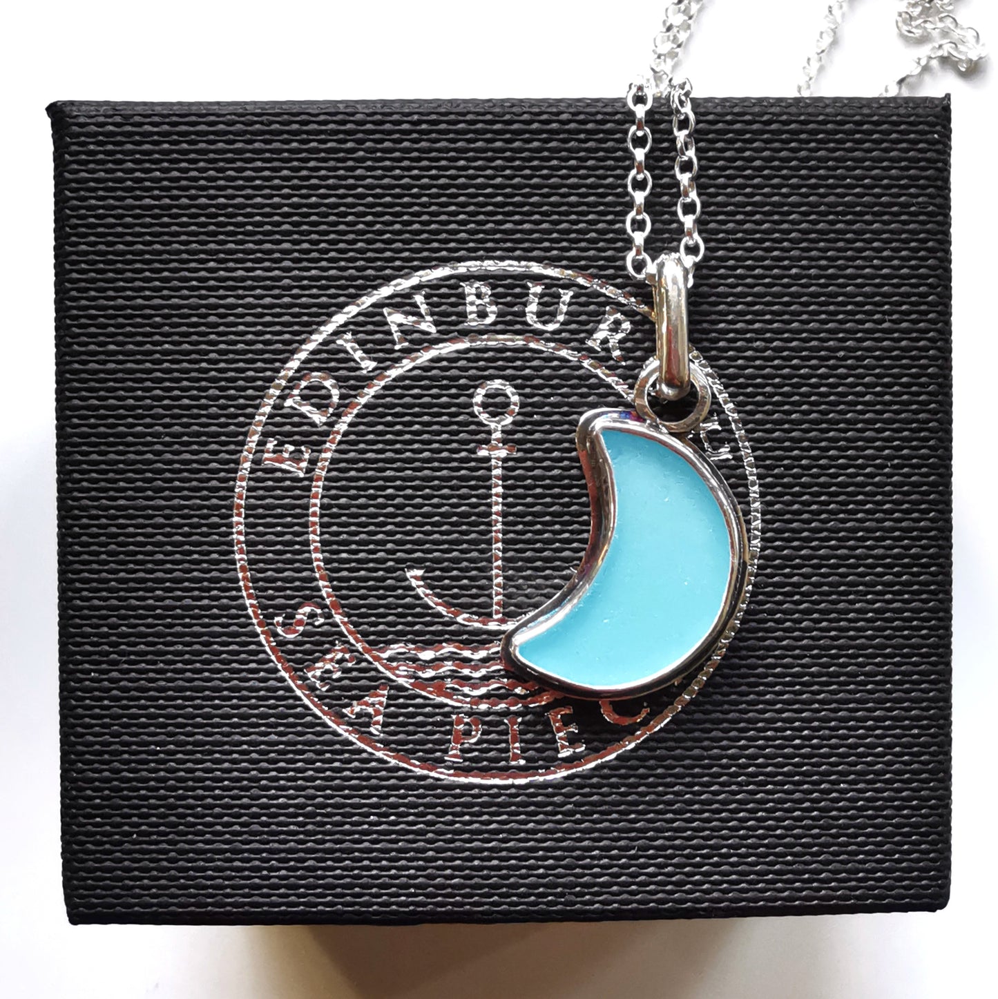 Aqua blue crescent moon sea glass & sterling silver pendant.