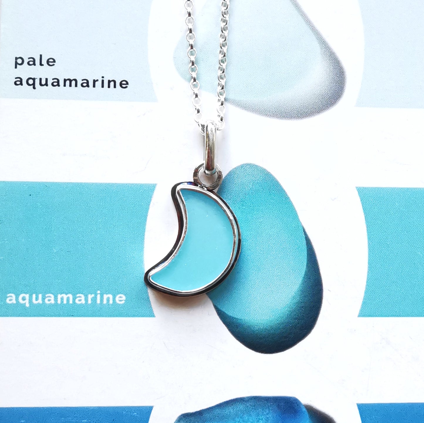 Aqua blue crescent moon sea glass & sterling silver pendant.