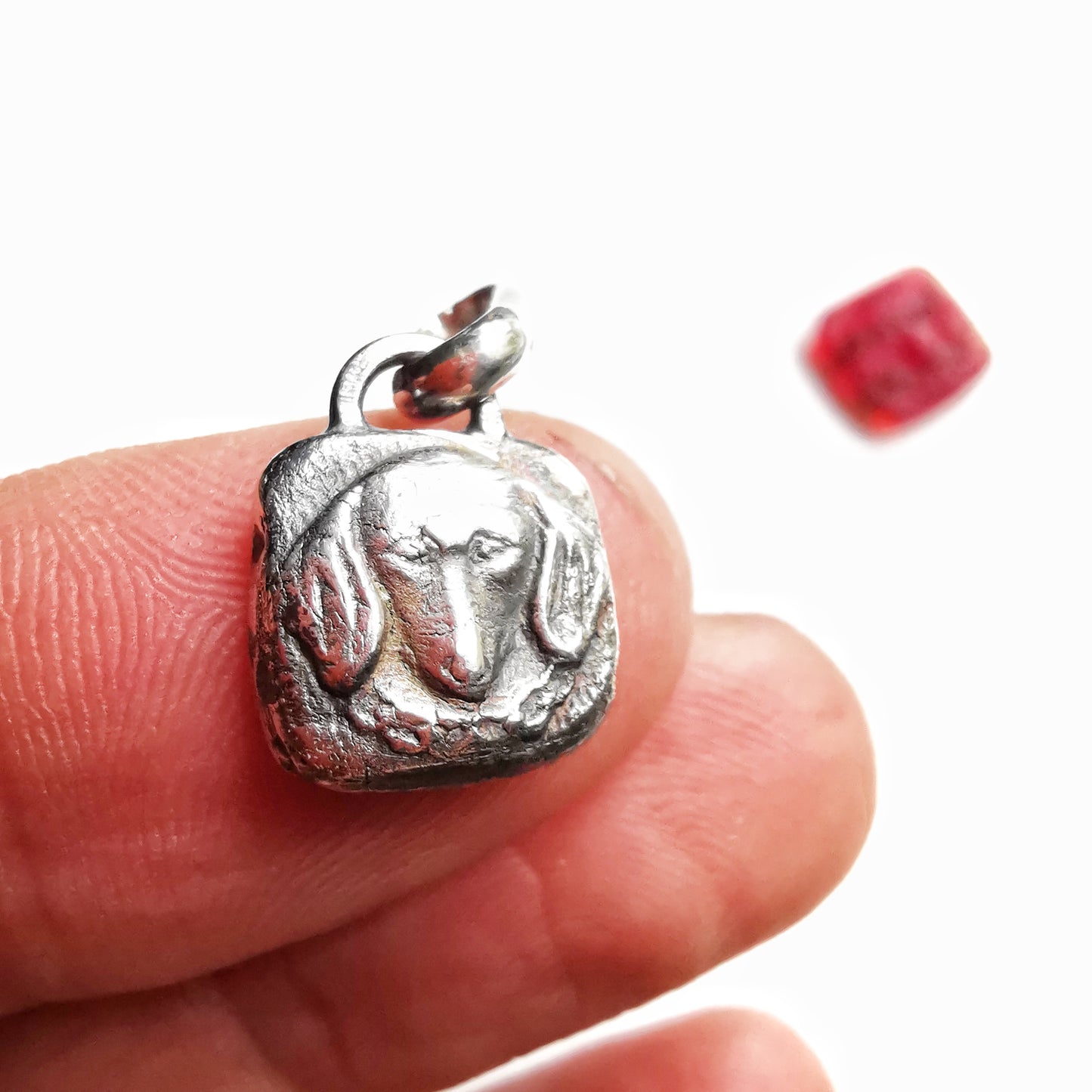 Silver dachshund pendant.