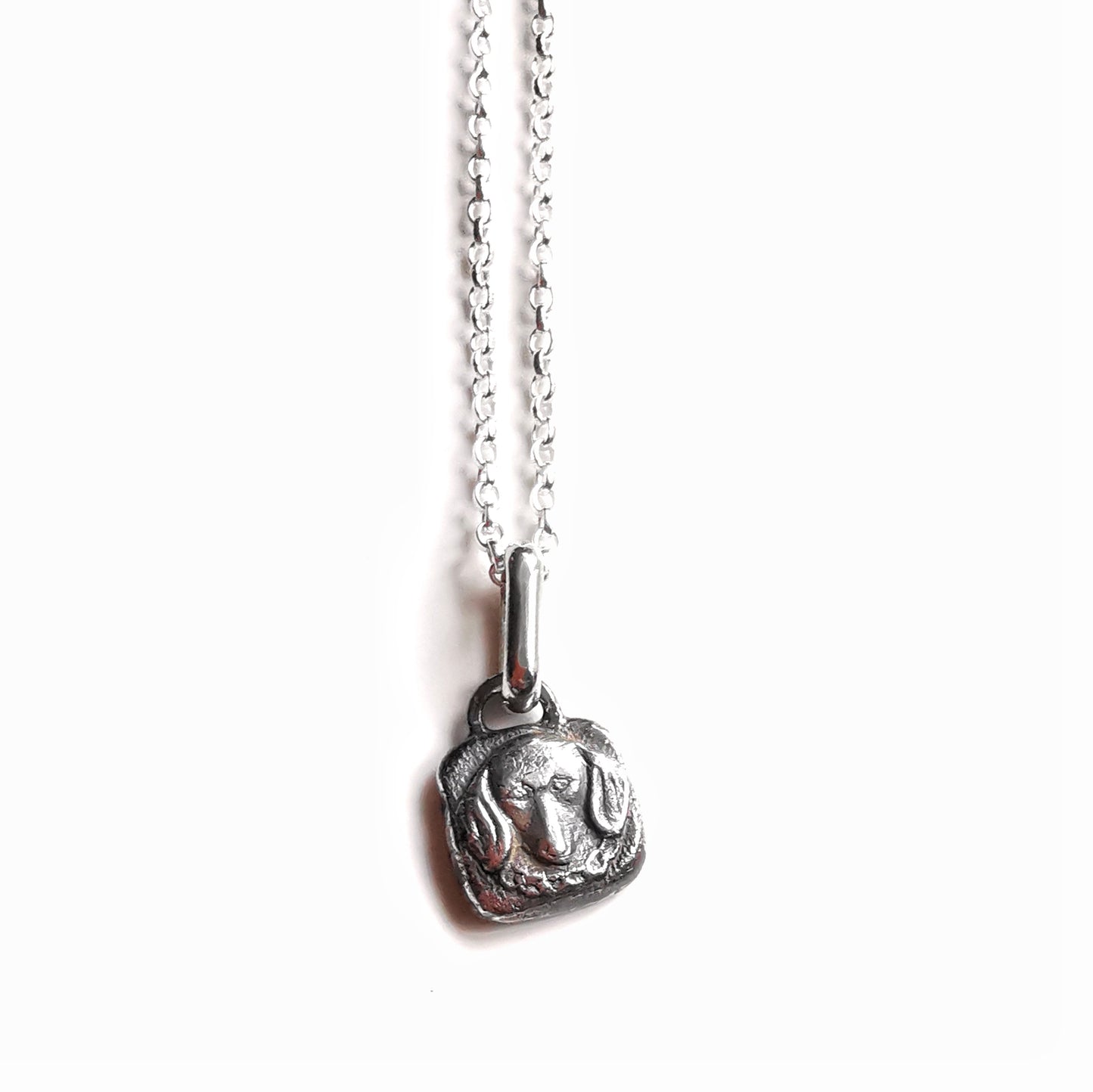 Silver dachshund pendant.