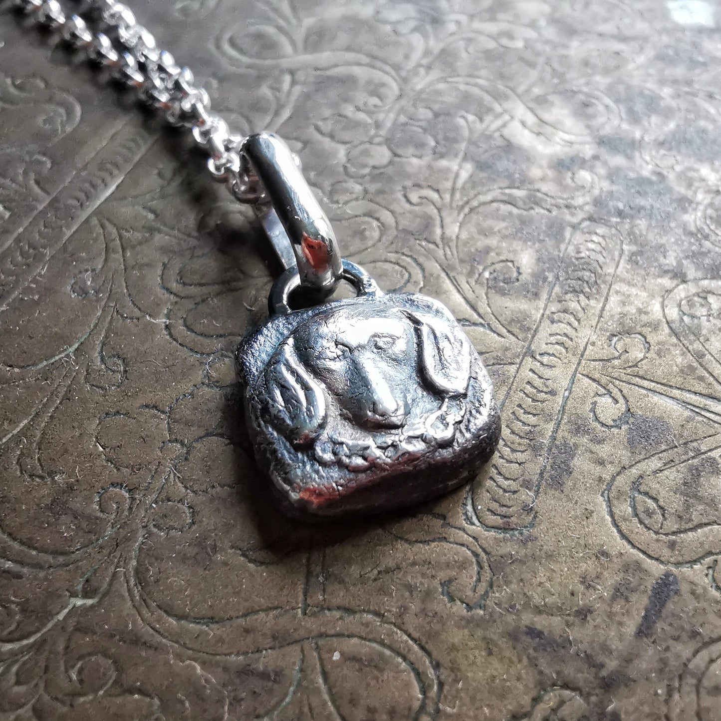 Silver dachshund pendant.