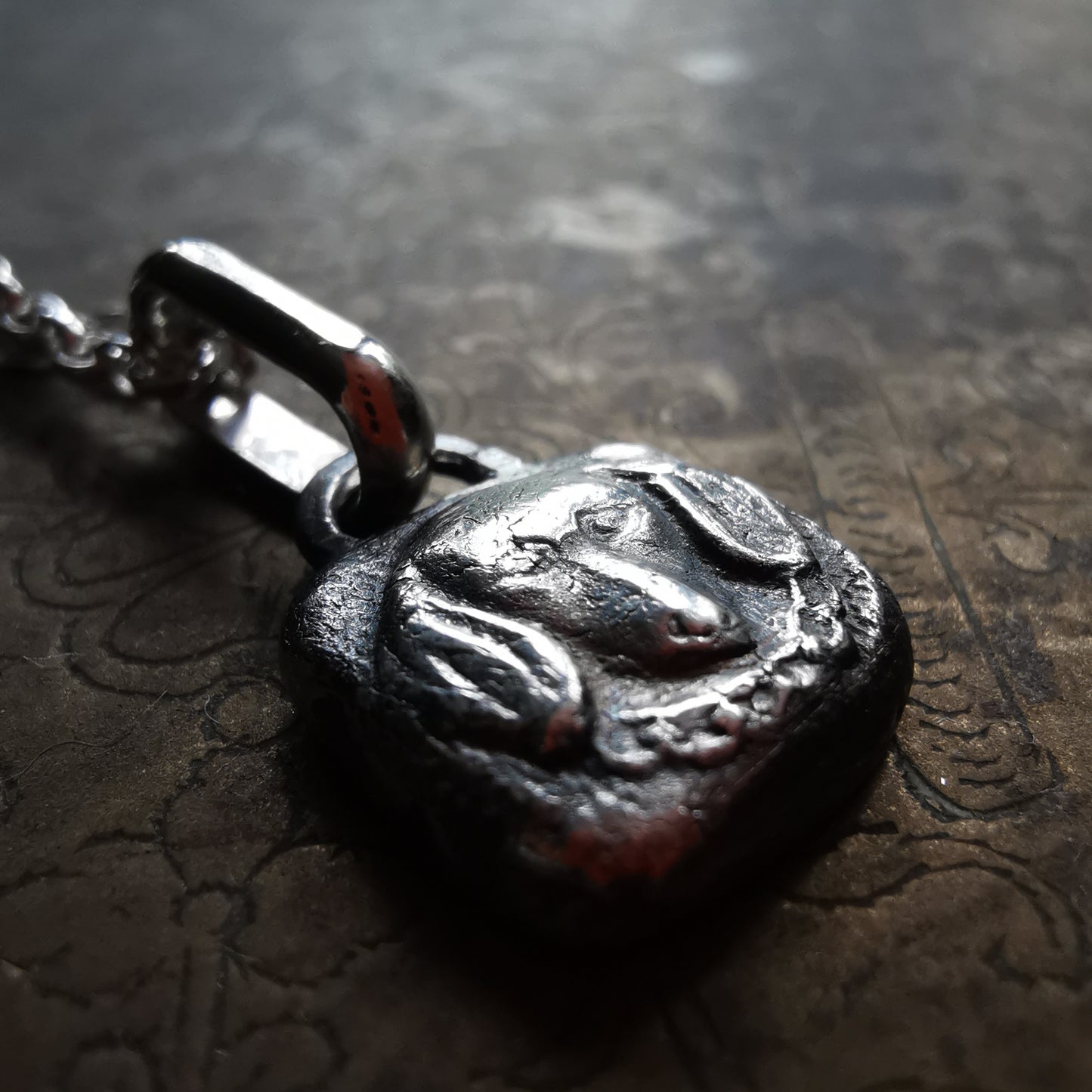 Silver dachshund pendant.
