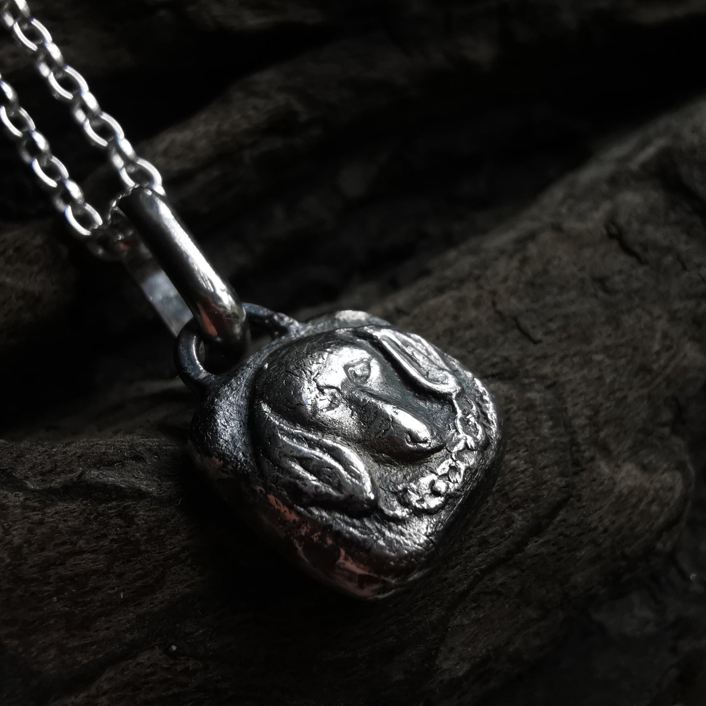 Silver dachshund pendant.