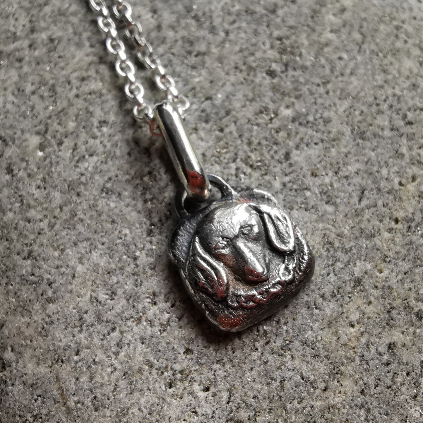 Silver dachshund pendant.