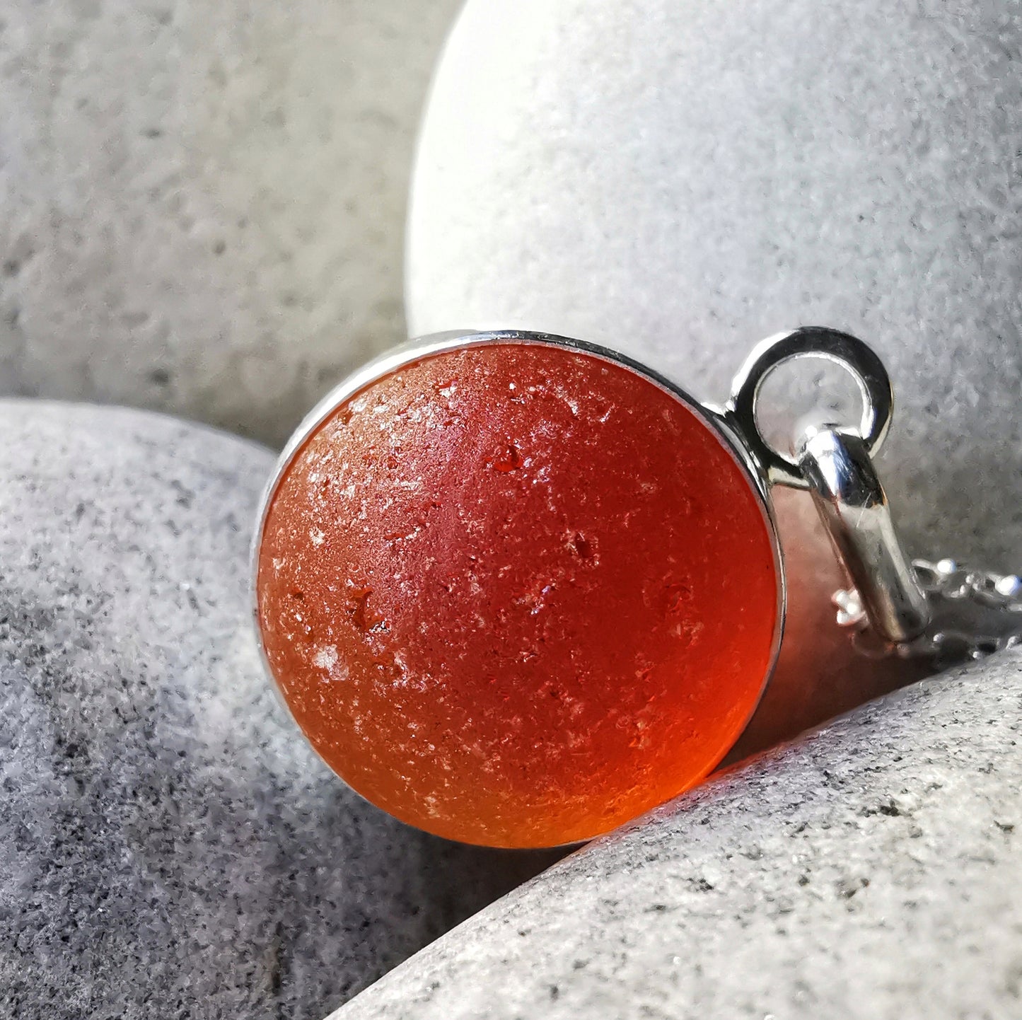 Genuine orange UV sea glass marble & sterling silver pendant.