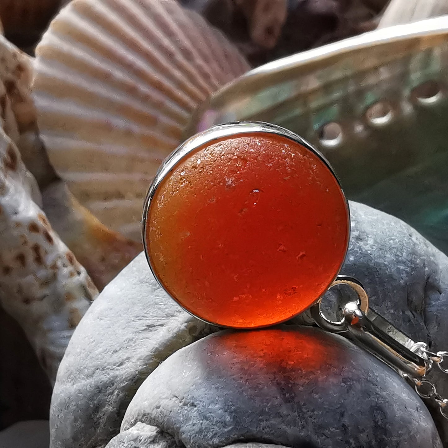 Genuine orange UV sea glass marble & sterling silver pendant.