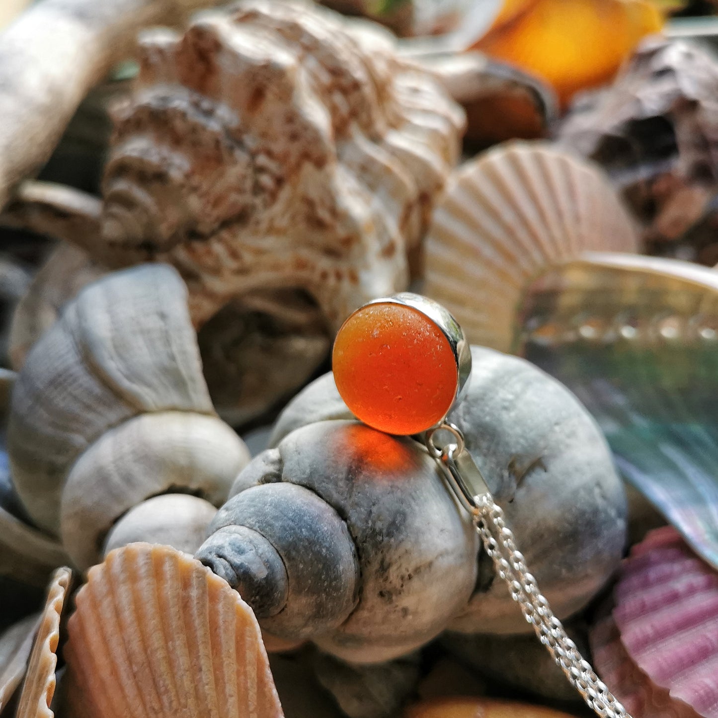 Genuine orange UV sea glass marble & sterling silver pendant.