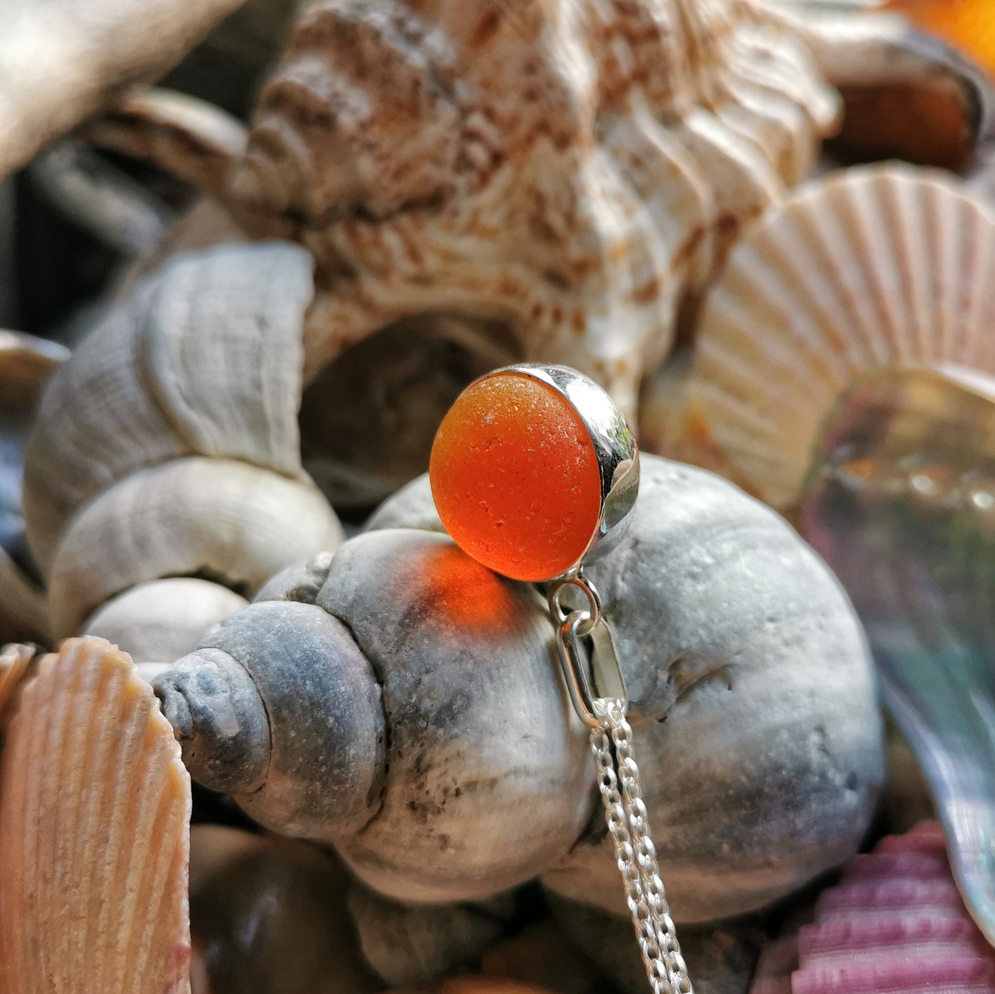 Genuine orange UV sea glass marble & sterling silver pendant.