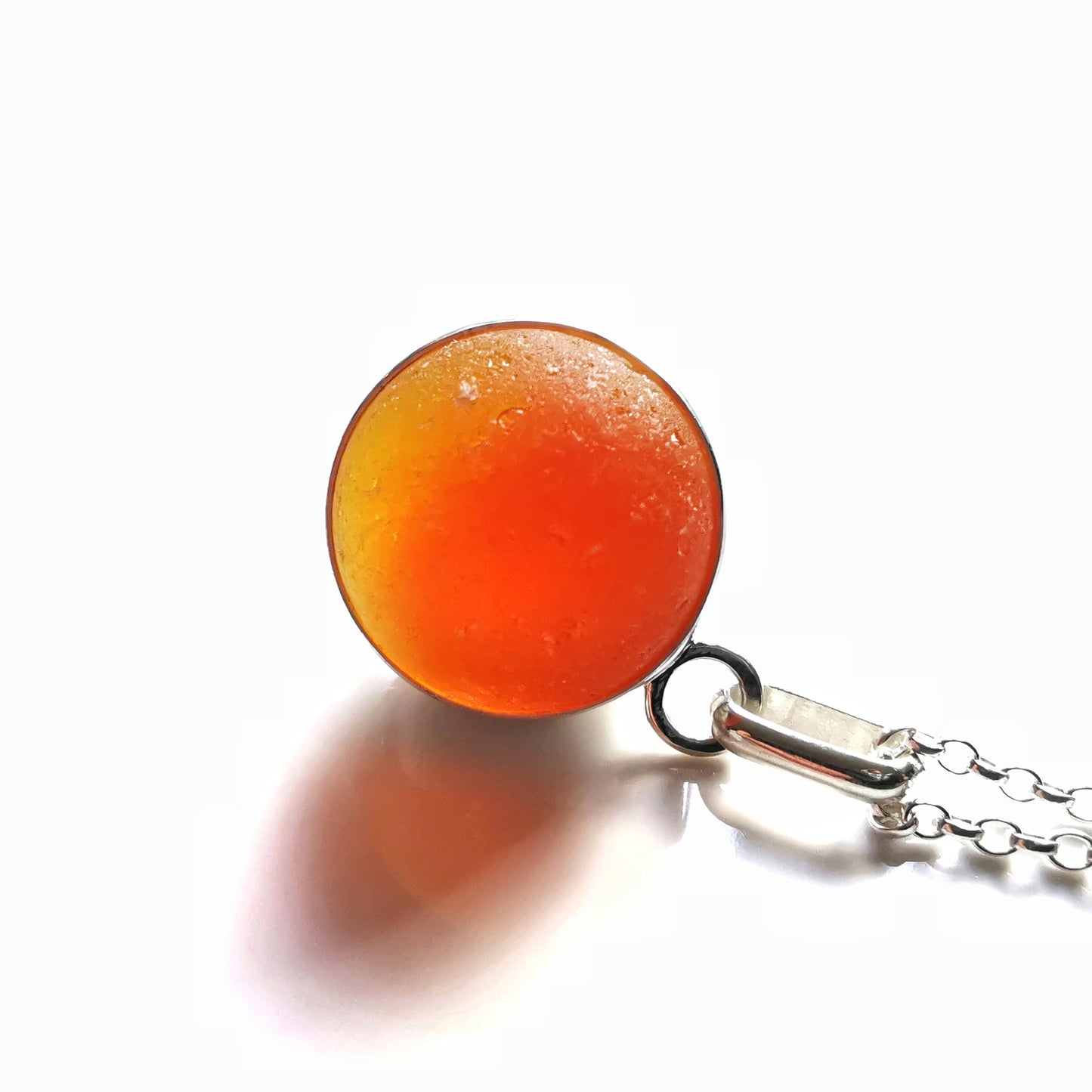 Genuine orange UV sea glass marble & sterling silver pendant.