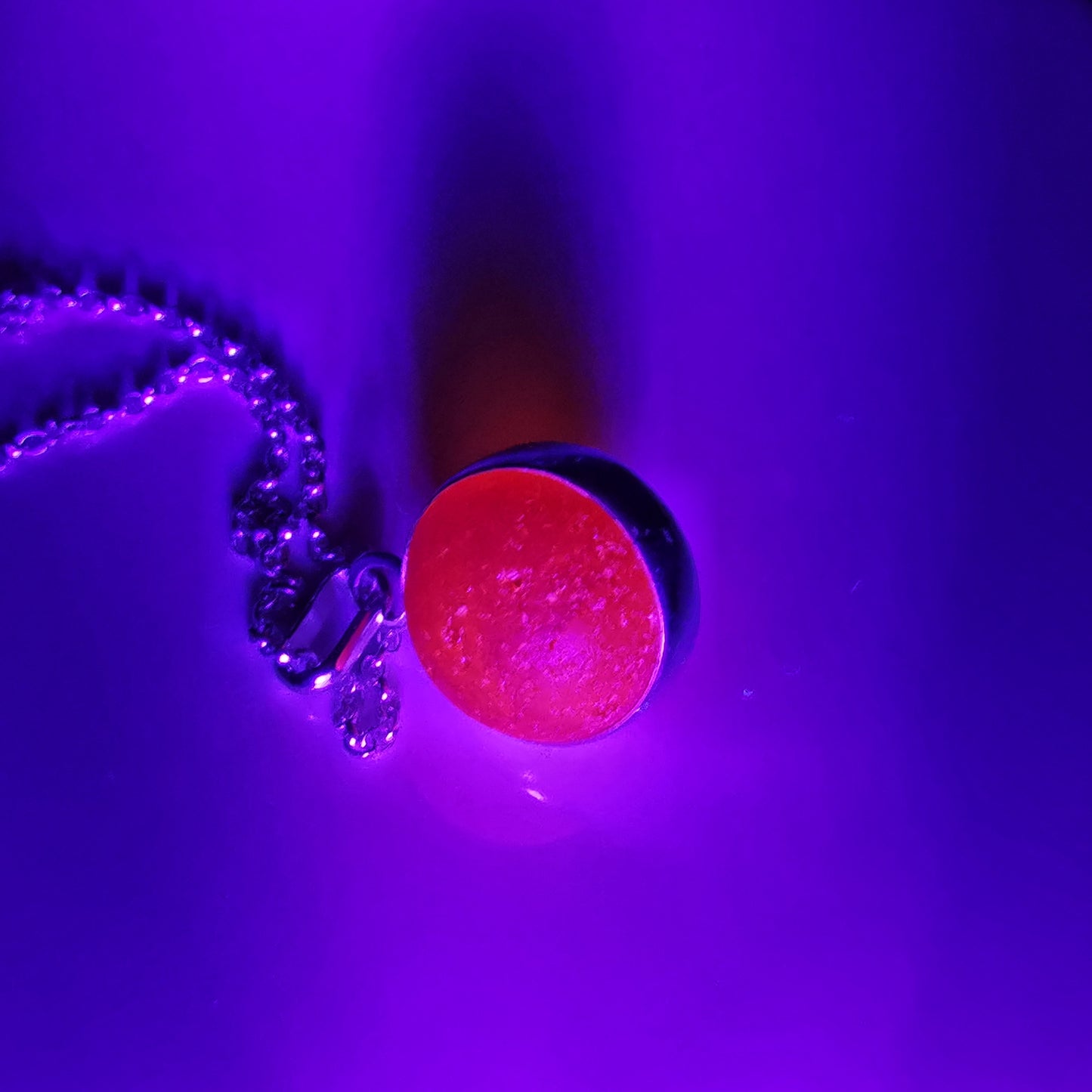 Genuine orange UV sea glass marble & sterling silver pendant.
