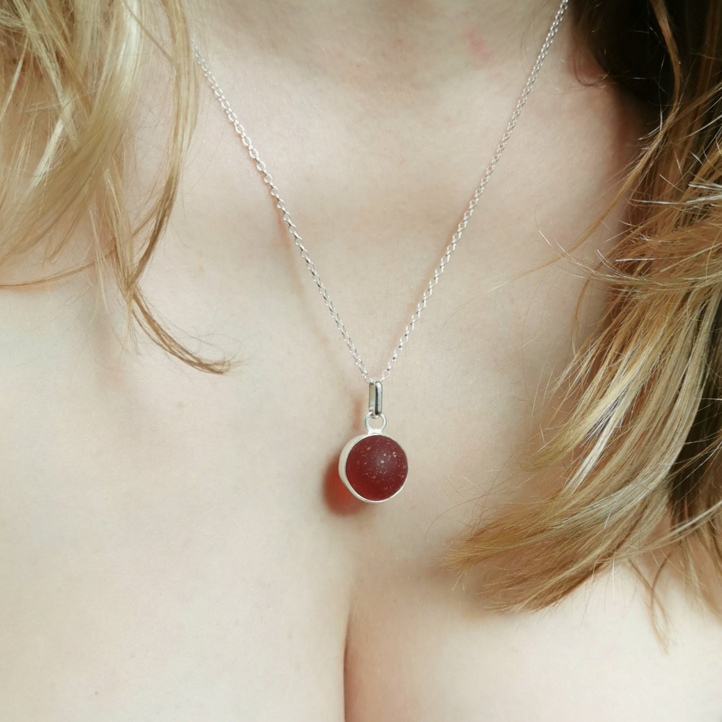 Genuine red sea glass marble & sterling silver pendant.