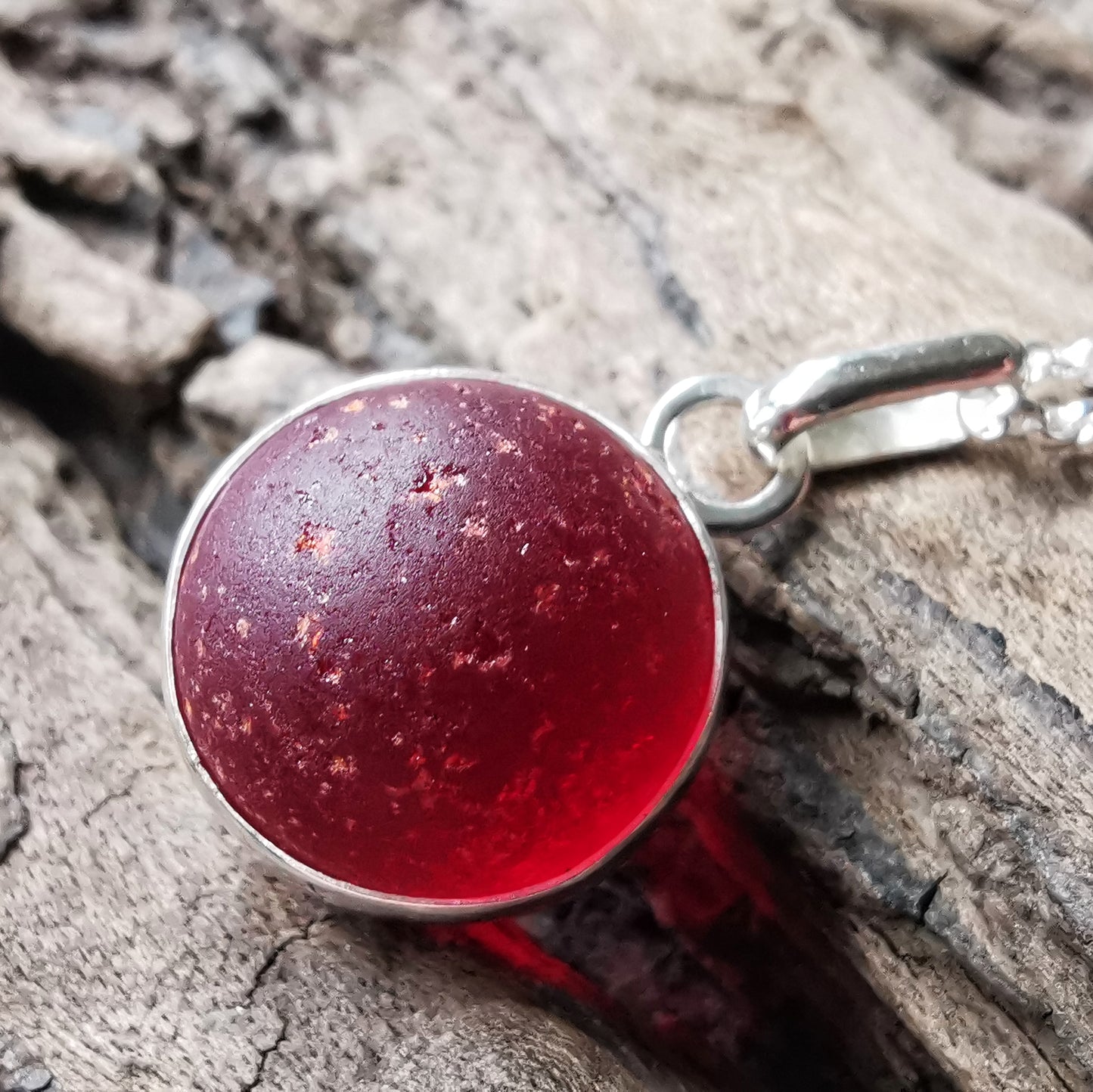 Genuine red sea glass marble & sterling silver pendant.