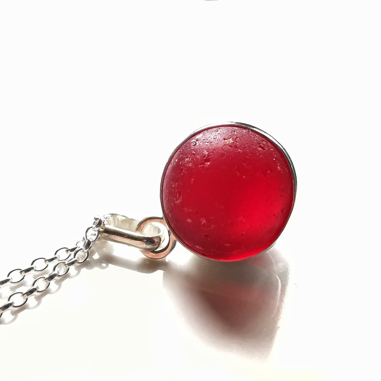 Genuine red sea glass marble & sterling silver pendant.