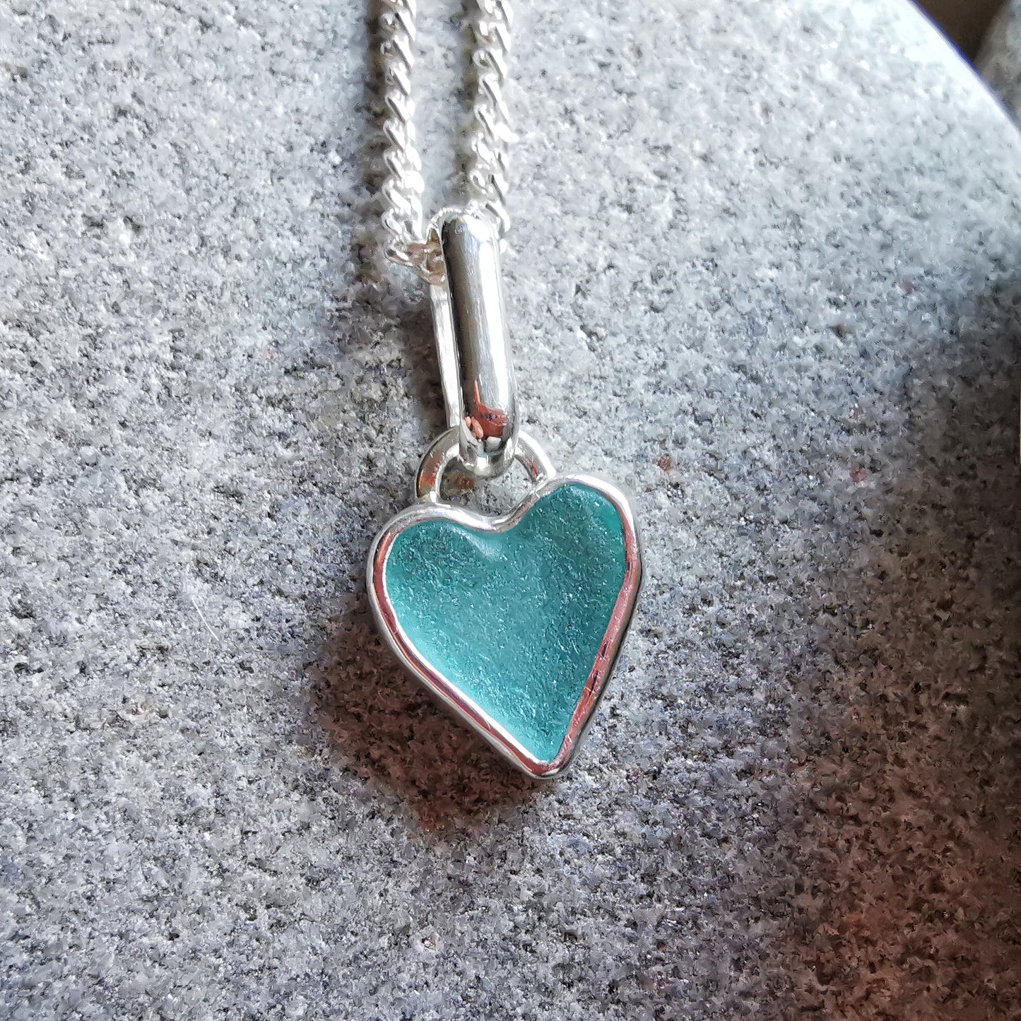 Aqua blue UV sea glass heart  & sterling silver pendant.