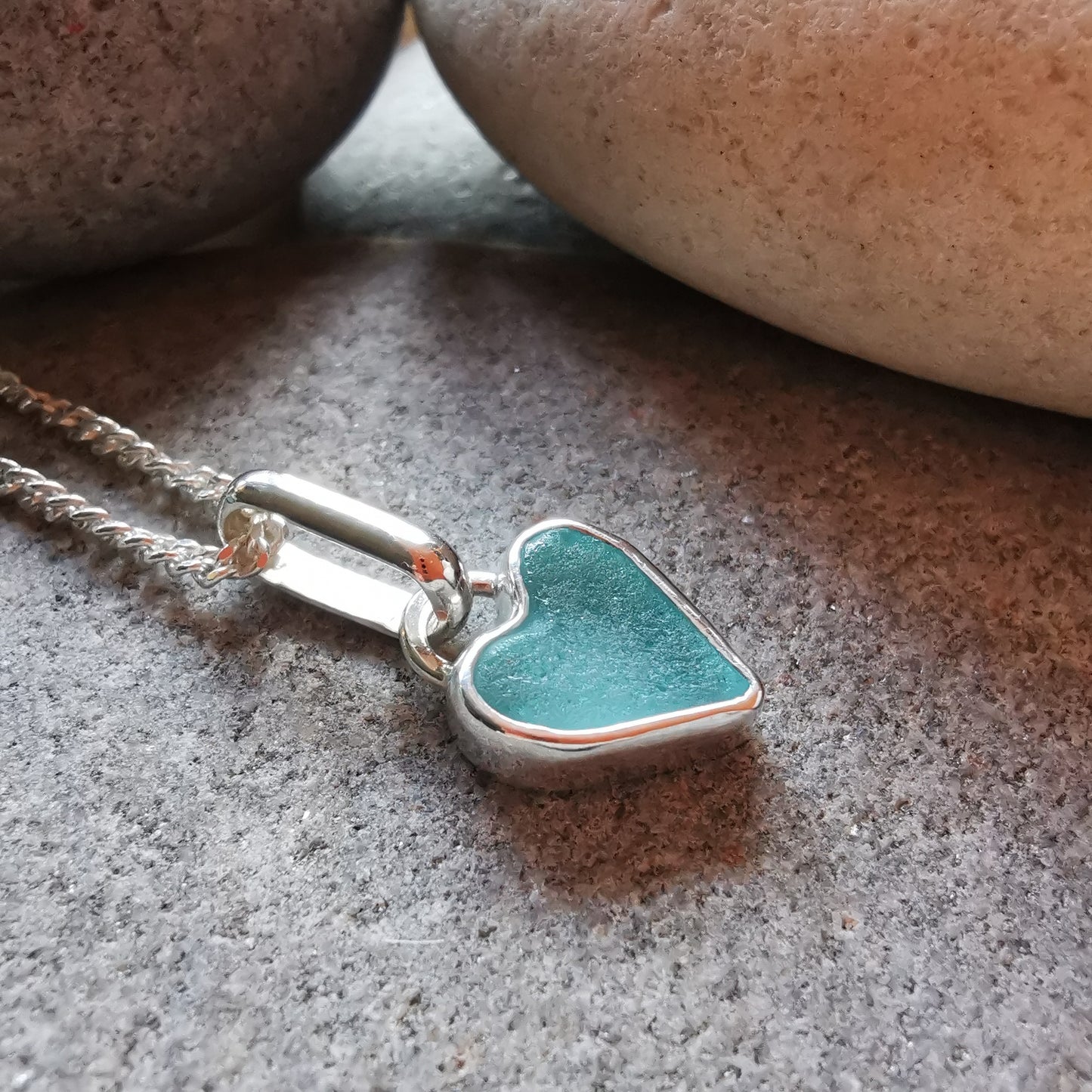 Aqua blue UV sea glass heart  & sterling silver pendant.