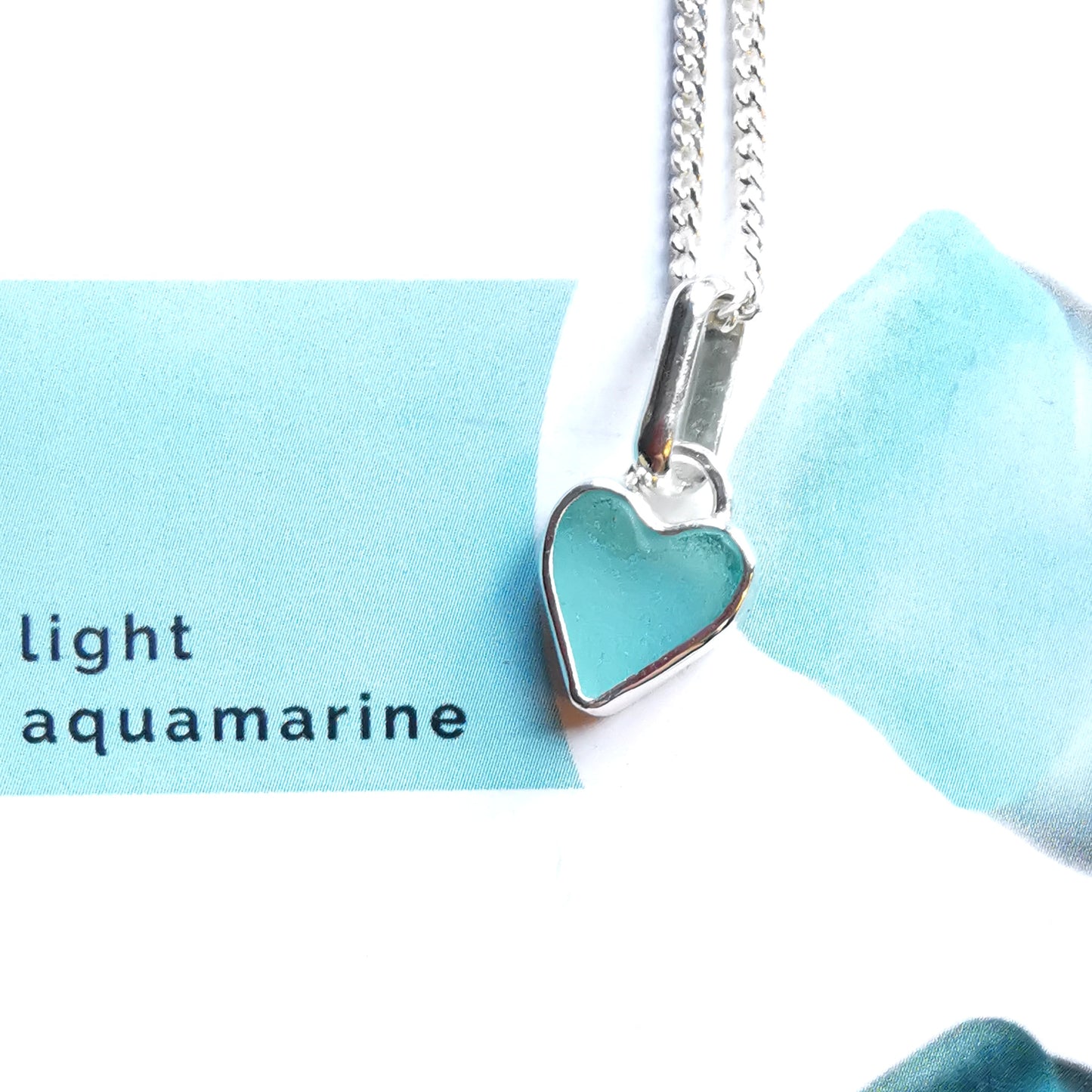 Aqua blue UV sea glass heart  & sterling silver pendant.
